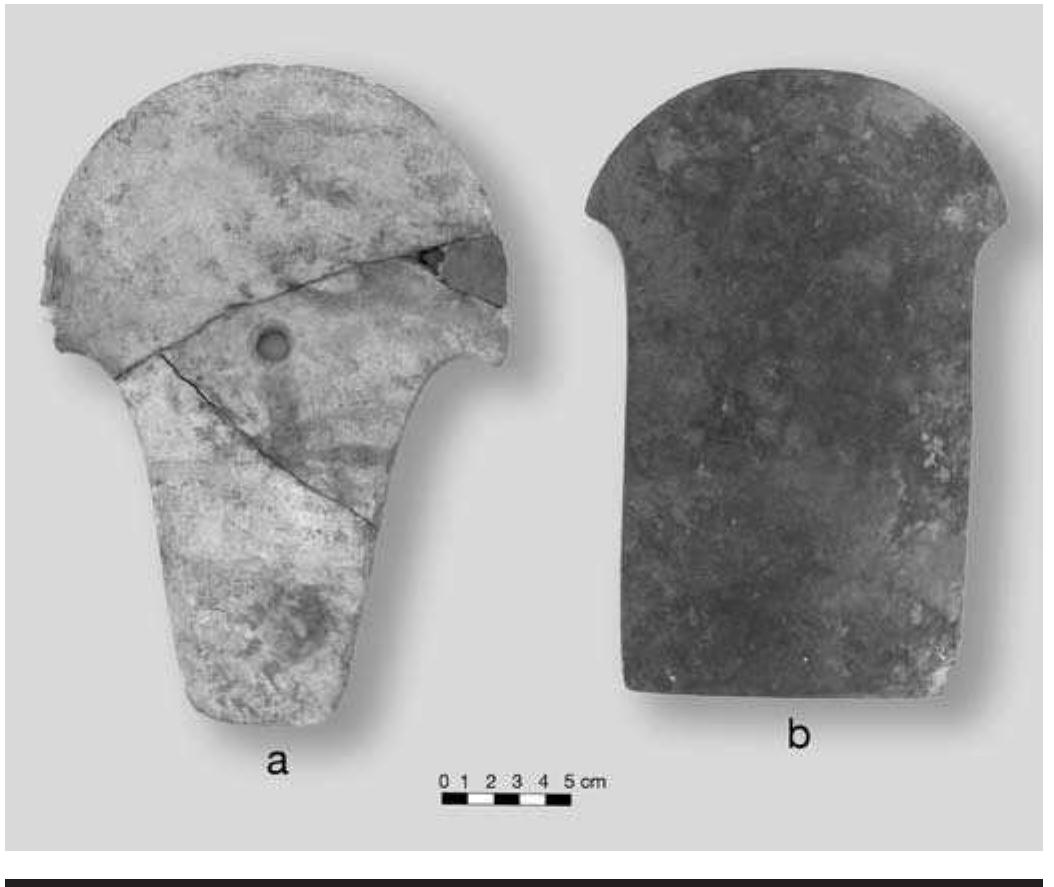 FIGURE 6.23. Spatulate celts: a, perforated marble celt (448674); b, large greenstone celt (448673).  ac  n/a” indicates data are not applicable.  > Complete artifact. 