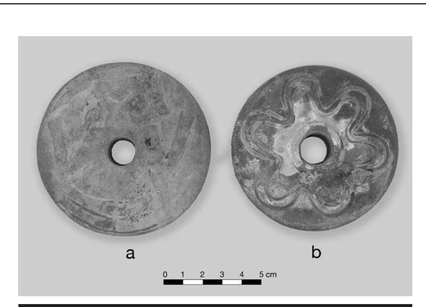 FIGURE 7.4. Perforated pulley-shaped earspool: a, human warrior figure design (423162); b, petaloid design (423163). 