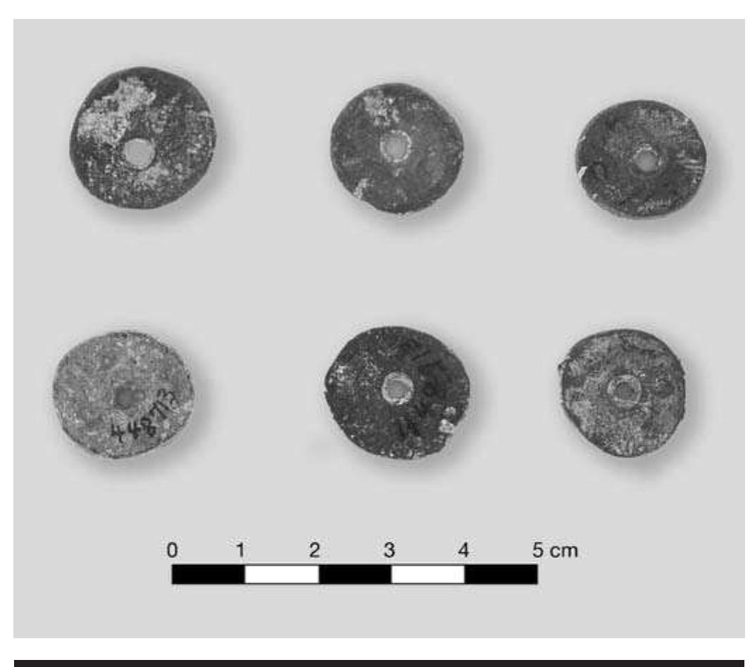 FIGURE 7.20. Copper disc beads—apparently fraudulent (448713).  TABLE 7.6. Frequency and characteristics of stone beads. A dash (-) indicates data nonexistent or not available; Max., maximum; Min., minimum. 