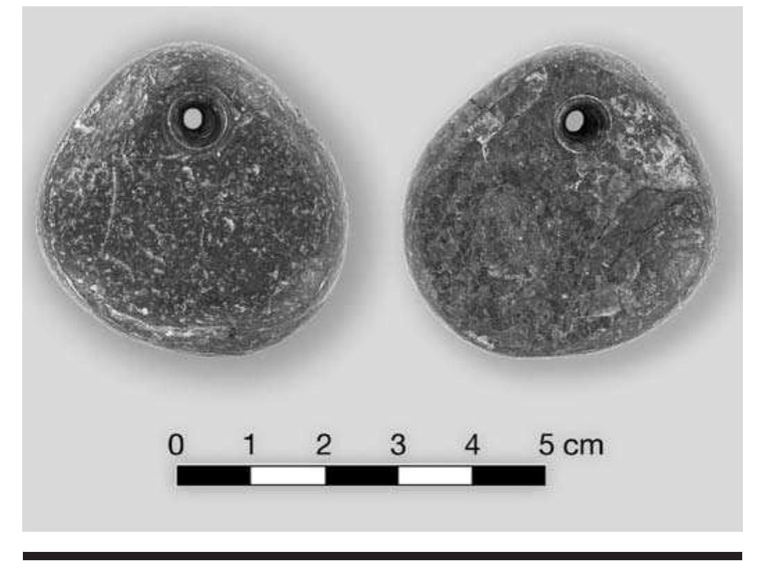 FIGURE 7.28. Cannel coal pendant, both sides (423167).  An odd pendant of greenstone is incised on one face (448684). This is an unusual design in that the stone is not simply drilled through the top to provide a point of 