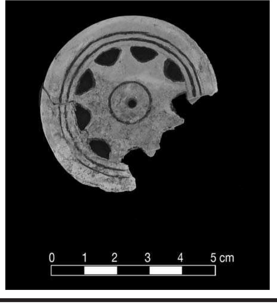 FIGURE 7.30. Circular fenestrated gorget depicting a sun symbol (448740).  only two examples are Craig B. Four of these circular gor- gets are decorated with a modified star with concentric circles (Figure 7.30). (See Brown, 1976: fig. 81g for an identical type in the University of Arkansas collection.) The style resembles a motif associated with Moundville (Fundaburk and Foreman, 1957). 