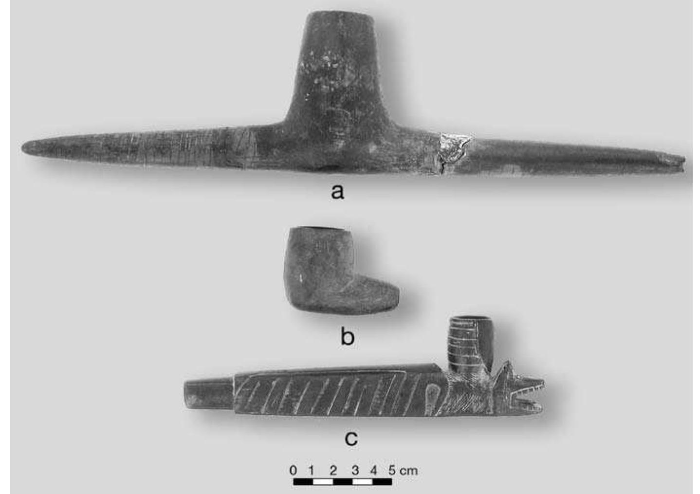 Artifact 379215 is the stem from a single Red River pipe. These pipes are ceramic, with a narrow, straight, polished stem and a bowl that sits squarely on one end. There are two sections that refit for a total 6.84 cm in length. The diameter is 0.76 cm. Bore diameter is 0.35 cm. The paste is a grog-tempered clay that registers 2.5YR 4/4 reddish brown on the Munsell Color Chart. There are no bowl fragments. Presumably, the stems are manufactured by rolling clay around a narrow reed. 