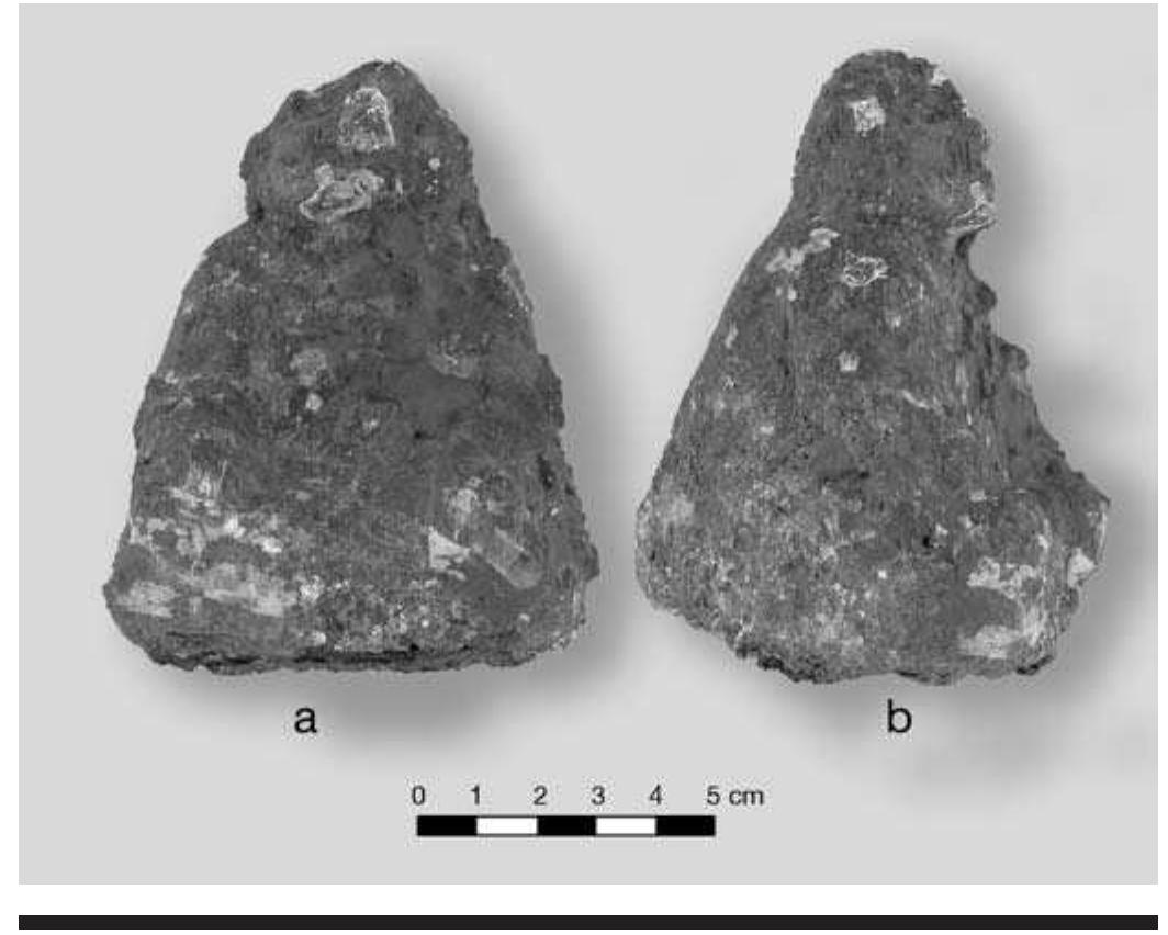FIGURE 8.19. Galena figurine (448706): a, front view; b, side view.  One human figurine was carved from a single lump of galena (Figure 8.19). The figure is seated, with arms resting on legs in a posture similar to that assumed by the wooden 