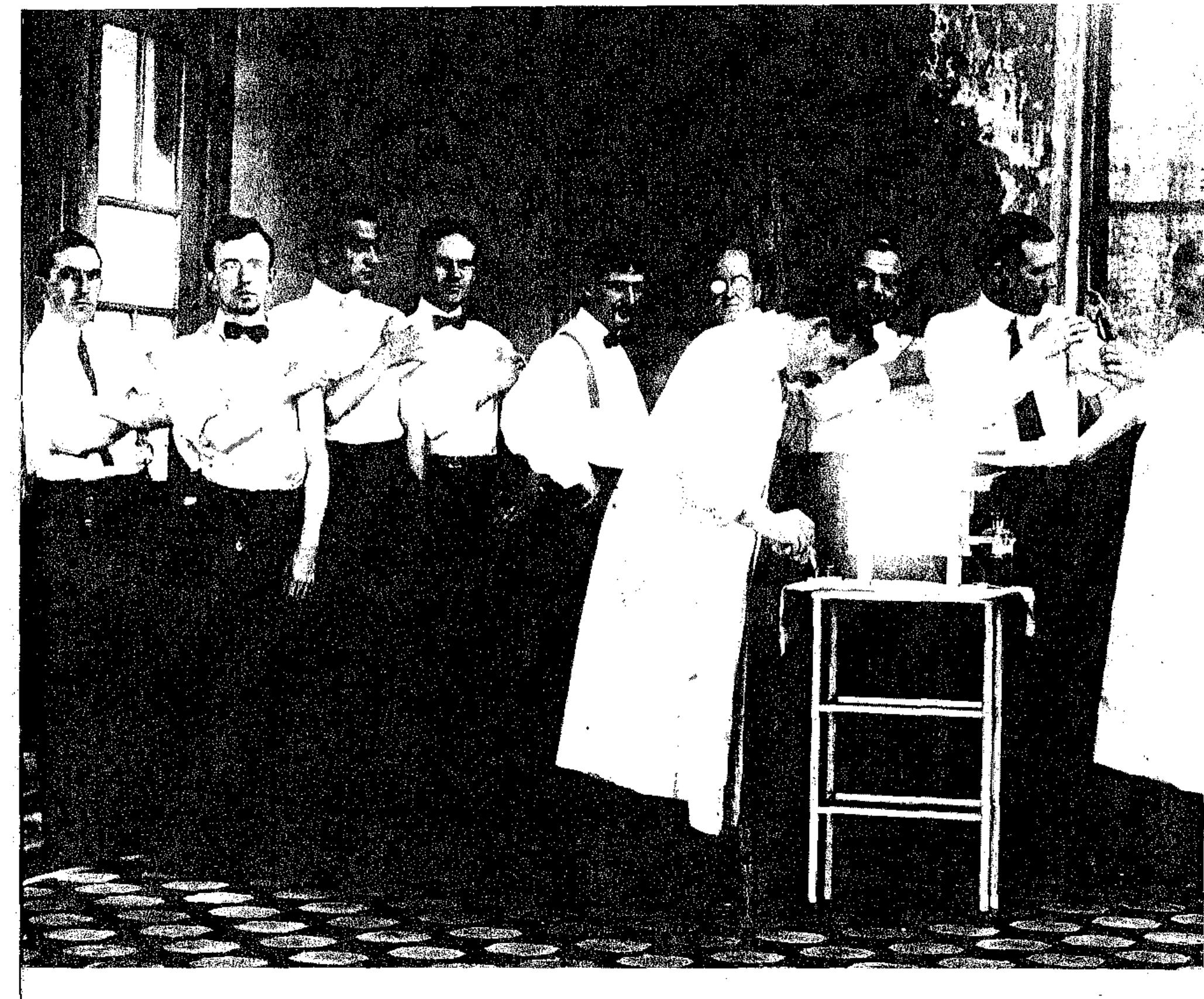 In white coats, Dr. John Neate (left) and Dr. F.F. Russell of the museum test their successfu typhoid vaccine on museum staff volunteers, 1908. 