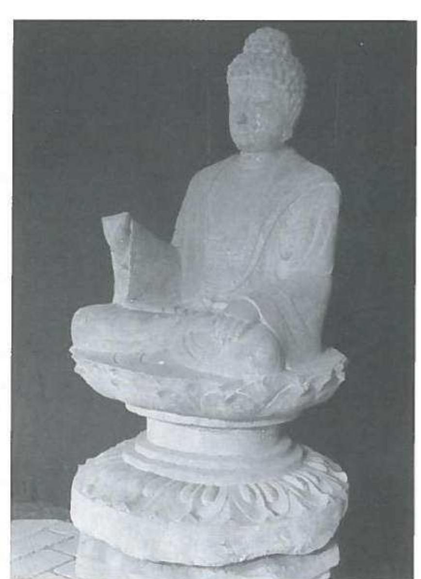 ) Seated Buddha, end of 7""- beginning of 8 centur A.D. Longmen Grottoes Academy. (Courtesy of the Guanlin Museum). 