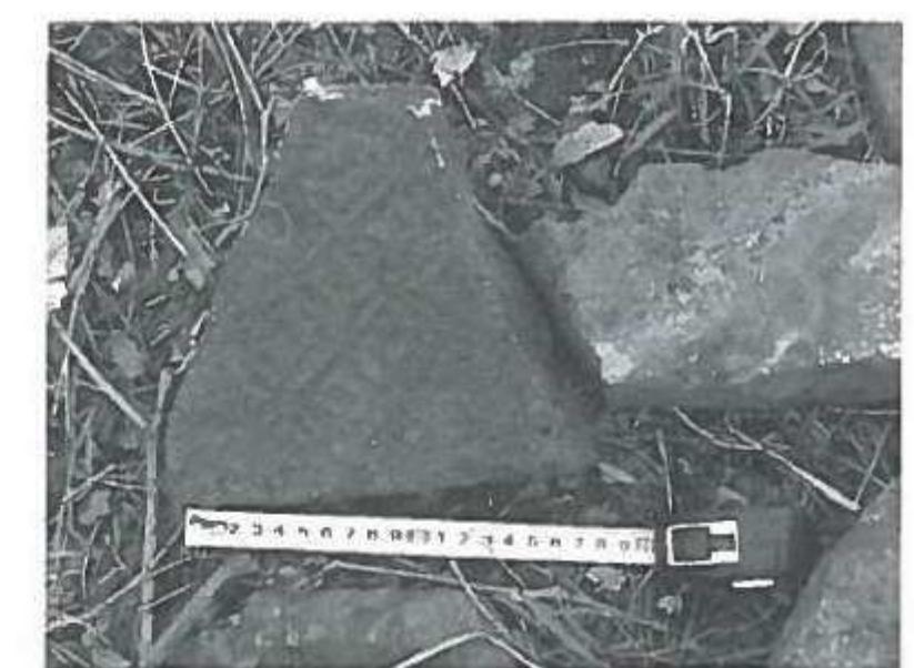 a) Fragment of brick with cross-shaped impressions on the back. Terrace 2 of the Xiangshansi site. (Photo by the author). 