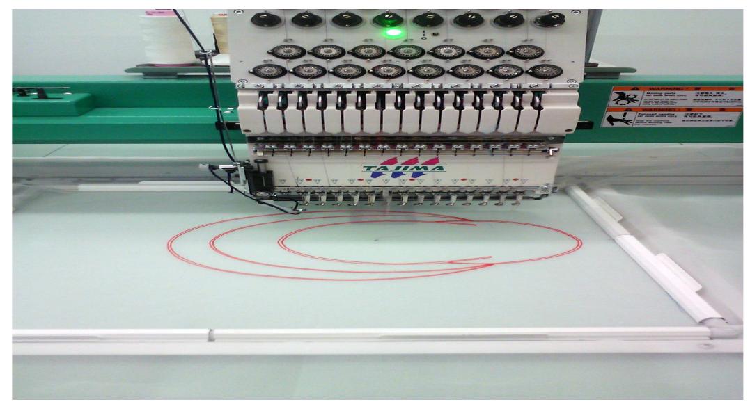 Figure 5. Digital embroiderer stitching neckline.  allow the product operate in a cradle-to-cradle model.  embroiderer bed size and ease of placement relative to the digital print, and the 