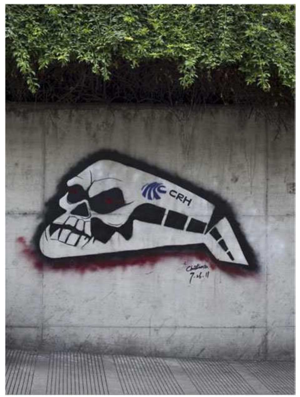 Figure 4. Graffiti in a university in Shanghai.  On 23 July 2011, a breaking news report shocked China and the world. Two high- speed trains running on the Yongtaiwen Railway collided with each other, resulting in a catastrophic derailing of the trains in the suburbs of Wenzhou, Zhejiang province. The subsequent actions taken by the officials of the Ministry of Railways, and the irresponsible answers given by the Ministry spokesman during the subsequent press conference, greatly outraged the public. In addition to the unexpected critical stance of the state-owned media in this case, the role of new media, above all the Chinese version of Twitter, Weibo, in providing a more open platform for information transmission and opinion expression for the general public is highly remarkable. Three days after the accident, freshly painted graffiti on a wall in the Shanghai Jiaotong University campus featured a skull-like high- speed railway train with blood-red paint along its bottom (Figure 4). This image was widely circulated via Sina Weibo, the Chinese version of Twitter. The graffiti’s critical message was straightforward in the context of the agitated public opinion at the time. Subsequent events intensified the drama. The following day, July 27, a photo of a man in the process of covering the graffiti with concrete in broad daylight, and an image of the covered-over section of the wall where the graffiti once was, were published. That evening, as if anticipating the erasure, the graffiti was repainted under the cover of darkness. The same whitewashing was repeated the next day, July 28, although the next graffiti that appeared was no longer the original skull-train, but a verbal message beside the  