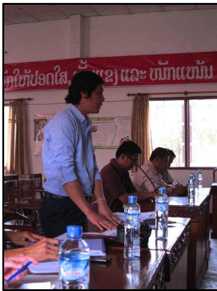 Image 2: Research coordinator Yhoksamay Lathsavong presenting BPIG in Hin Heub District.  The trip’s first stop was for a meeting at the Vientiane provincial administration in Viengkham District. We presented BPIG to representatives from numerous provincial departments, including the Governor’s Office, Department of Energy and Mines, Department of Natural Resources, Department of Foreign Affairs, and Department of Planning. A number of officials had clarifying questions about the project’s purpose and methods, but once they fully understood it, they welcomed us, saying we could provide valuable assistance in implementing government policy. We learned that an EIA had been conducted for Nam Lik 1 but had been rejected by the provincial  governor because it did not appropriately consider livelihood impacts and the compensation nlan was inadequate. 
