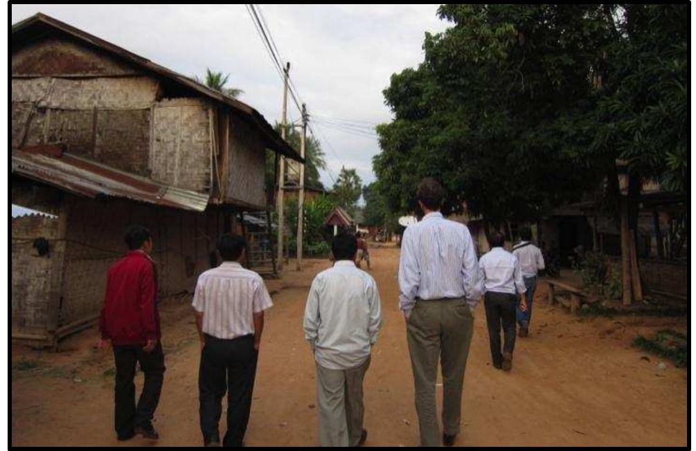 ) Image 3: District and provincial officials and a BPIC project consultant walk through Ban Hatkhip.  Notes from Nam Ou 2: Luang Prabang Province and Ngoy District 
