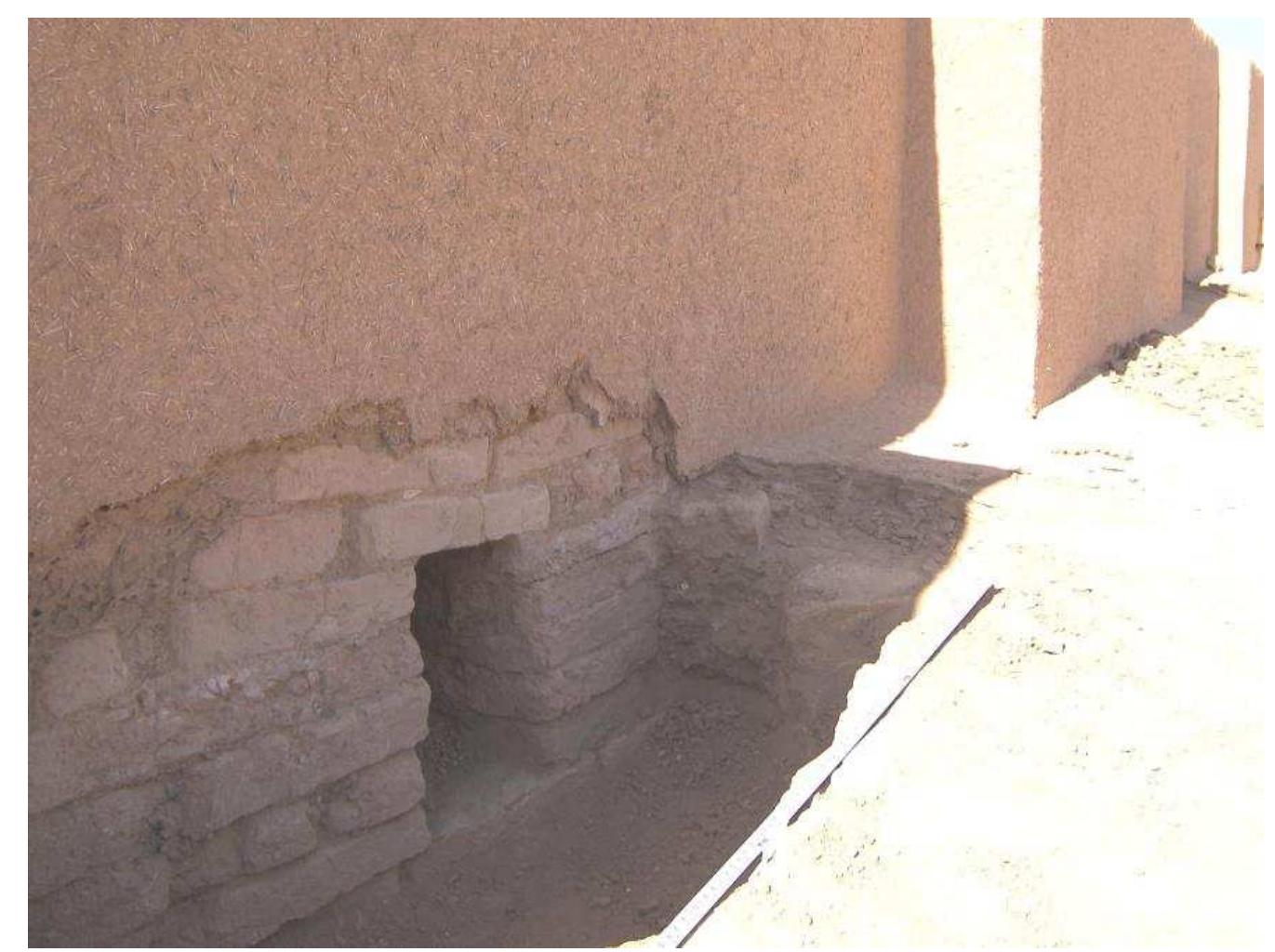 Fig. 7: Drainage canal near the western gate of the inner wall.  Iso the feature near the pit of the south western entrance of the ziqqurrat showed that the curr avement was built after a fire, which burnt most likely the gate of the ziqqurrat at this side, beca unt wood fragments and glass ornaments of the gate were found close to the pit aperture under  t””. So originally the pavement around the ziqqurrat was situated at least 25  urrent brick pavemen eeper and was about 75. 69 m. This is the same level of the surface in front of the entrance of 1Susinak temple A in the initial courtyard at the beginning building stage (Fig. 8). The area close  1e ziqqurrat at the south eastern side was hence originally only about 50 cm higher than point 2. T]  1e border of the first terrace in this part must have been at this time about 8.91 m high and the so  round the ziqqurrat about 1.3 m high.  TS eompeeee: wel! Dee: pe eek: Lawes aw eek Bla non was leper olla eateries wxqecn eet + Pax 41 teen wo hn  Also the feature near the pit of the south western entrance of the ziqqurrat showed that the current 