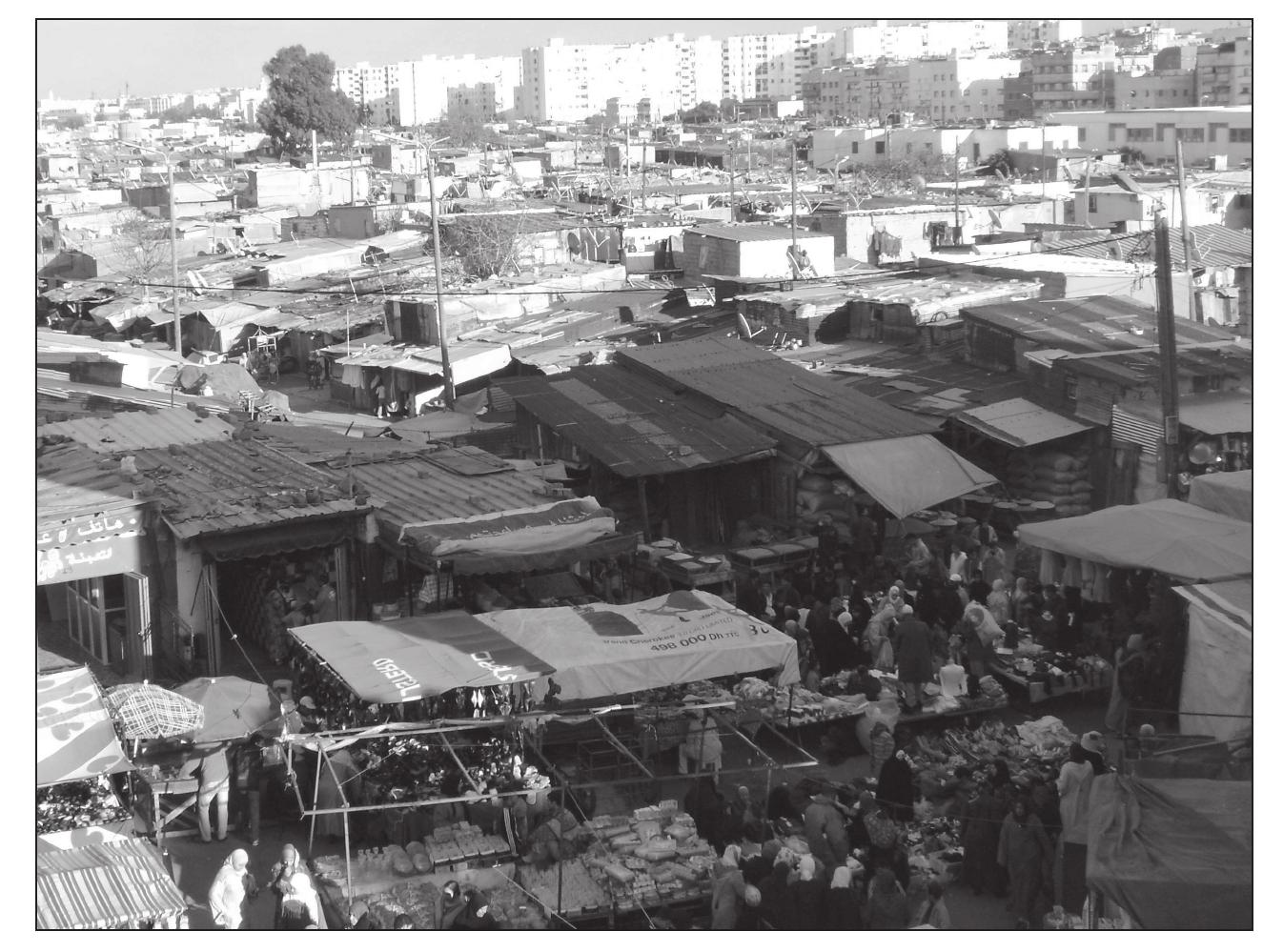 ss . 2°. = SS eT ee ee SS SLU ee eee ee eee eS ee ee ae  However, the greatest problem was, without a doubt, the fact that ever larger num- bers of rural-to-urban migrants were unable to find a job. Initially, these people pitched tents or built huts. Yet, when their financial situation did not improve they started to build slums out of scrap materials. One of the first shanty towns to be founded in this way was Carriéres Centrales. These slums, which later became a breeding ground for the Moroccan struggle for independence, were inhabited by jobless rural migrants and poor laborers from the nearby power plant Centrales Thermiques des Roches Noires (Adam 1968b). Despite the fact that several attempts have been made to move the inhabitants to social housing projects, the shanty towns continue to exist to this day. This is the case with many slums. A great exception is the shanty town of Ben MSick, a large shanty town which disappeared completely and its inhabitants were successfully re-housed in Hay Moulay Rachid (Adam 1950; Benkirane 1993).  At the end of the Protectorate probably some 150,000 people were living in shanty towns. However, we would make a great mistake if we assumed that the rest of the  At the end of the Protectorate probably some 150,000 people were living in shanty 