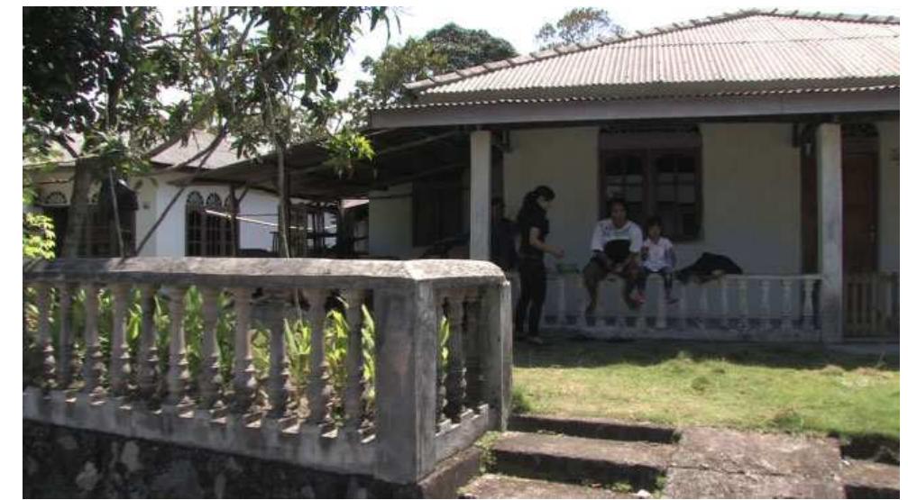 FIGURE 4. Semangka (00:27): https://vimeo.com/135894281.  The interview concentrates on the couple in front, who turn out to be the parents of the child. The house is their neighbor’s, and they are “just relaxing” (main aja). Originally, they are from Yogyakarta (Central Java). They have come to Kawal, the young man explains, to find work. “It is better here (enak di 