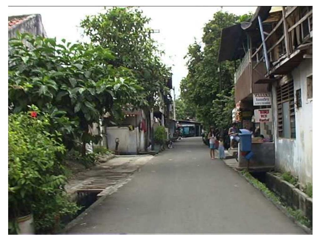 FIGURE 12. Film still of Jalan Sentul 2003.  Four years later, the exact same spot produces this. very different, view (Figure 13). 