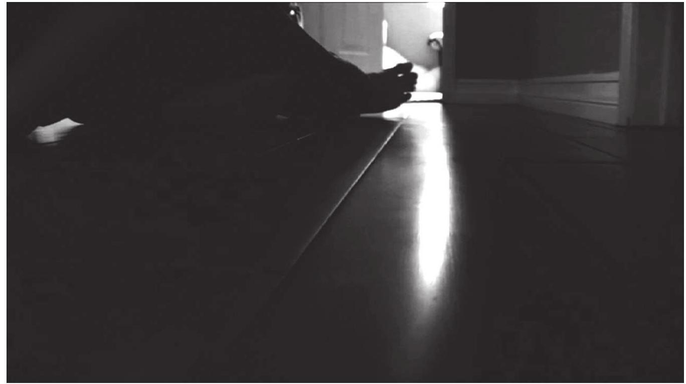 Figure 1. The frame often fails to contain bodies: we see only Micah’s foot and Katie’s arm as he comforts her in Paranormal Activity (Paramount, 2007). 
