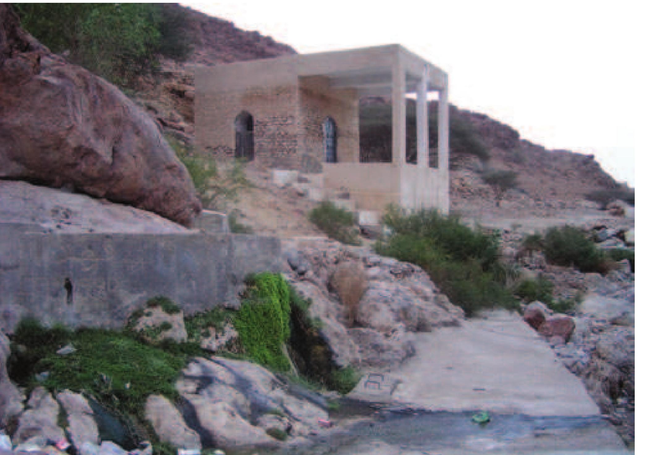 cleft asunder, and disclosing a deep fissure or chasm, at the bottom of which lies the well; it is dreaded and revered by the superstitious Beduin as the habitation of magicians. The water is said to have become red from the blood of an unfortunate wretch who lies imprisoned by enchantment deep down under  the spring, and it is affirmed that anyone venturing to drink of it falls immediately under the spell and power of the magician ... hard  by are to be seen the crumbling ruins of the tomb of a saint ... it is possible that it marks the site of an idolatrous and pagan temple of the pre-Islamic Arabs. (Miles 1910: 169)  from it”.'® This serpent ‘dwelled’ within the well and was only removed by a divine bird when the Quraysh proceeded to reconstruct the Kacbah in 605 AD after a flash flood (sayl) had destroyed it. The interesting point to note is that although none of the traditions associated with the well of the Kacbah talk of anything to do with water, it has been frequently referred to as a bi'r,'” which usually implies “a water source, a well or possibly a spring” (Hawting 1980: 51-52). It is thus possible that this semi-mythical  pit located within the Ka*bah, and the ‘Ayn Zamzam located within the sacred precinct, were used interchangeably (Hawting 1980: 51, also 50). Some scholars have compared this well (or pit) of the Katbah with the ghabghab of pre-Islamic sanctuaries, which were not only the receptacles of sacred treasure, but were pits in front of idols into which the sacrificial blood flowed (Hawting  fountain or a holy stream is noted more amongst the settled Arabs than the nomads and has had a continued relevance (12). The medicinal and sacred waters were often inhabited by the jinn, usually in the form of serpents (Robertson Smith 1927: 167-168).'5 Jurnan (or Jarnan), the idol reputedly worshipped in Izki north of Manah, was located in a cavern (or cave — kanisa) on the cliff crowned by one of the two principal hujra (residential quarters), Nizar (Wilkinson 1977: 236 n. 3; also, Carter 1982: 114). The local belief is that to reach this cavern and to see the idol, one had  to crawl through a narrow low opening guarded by. snakes (Skeet 1985: 120).  A awn mwd inn ern OV, ee ee en 