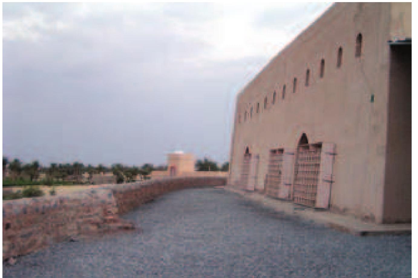 Figure 26: Masjid al-Jamis in Harat al-Bilad, Manah is placed on a raised terrace with ancient burial (a), its retaining structure acts as a dam to protect the sanctuary from the surrounding wadi  that acts as storm water drainage (b).  Negev, as we have seen, the forecourts to the square sanctuary cells varied from being square to semi-circular with a low enclosure wall of a few courses of stone, a description which could easily be appliec to mosque forecourts in Interior Oman.  appear to be integral to the construction of sanctified ground on which the Omani mosques sit. The other Manhi mosques are also examples of this; the Masjid ar-Rahbah even derives the name from its high plinth.  rising above the low enclosure wall — reflects an ancient precedent present in Negev of undressed or dressed stelae set into the ground or built into the wall on either side of an entrance (Nevo & Koren 1990: 34-35). 