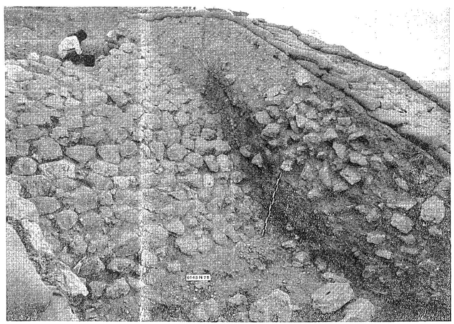 “ig. 12. The stone-faced glacis in front of the main city wall. Note the ‘perforated stones’ at the foot of the glacis and — seen in the section — the boulders of the second stage of the siege ramp dumped against the glacis, from southwest. 