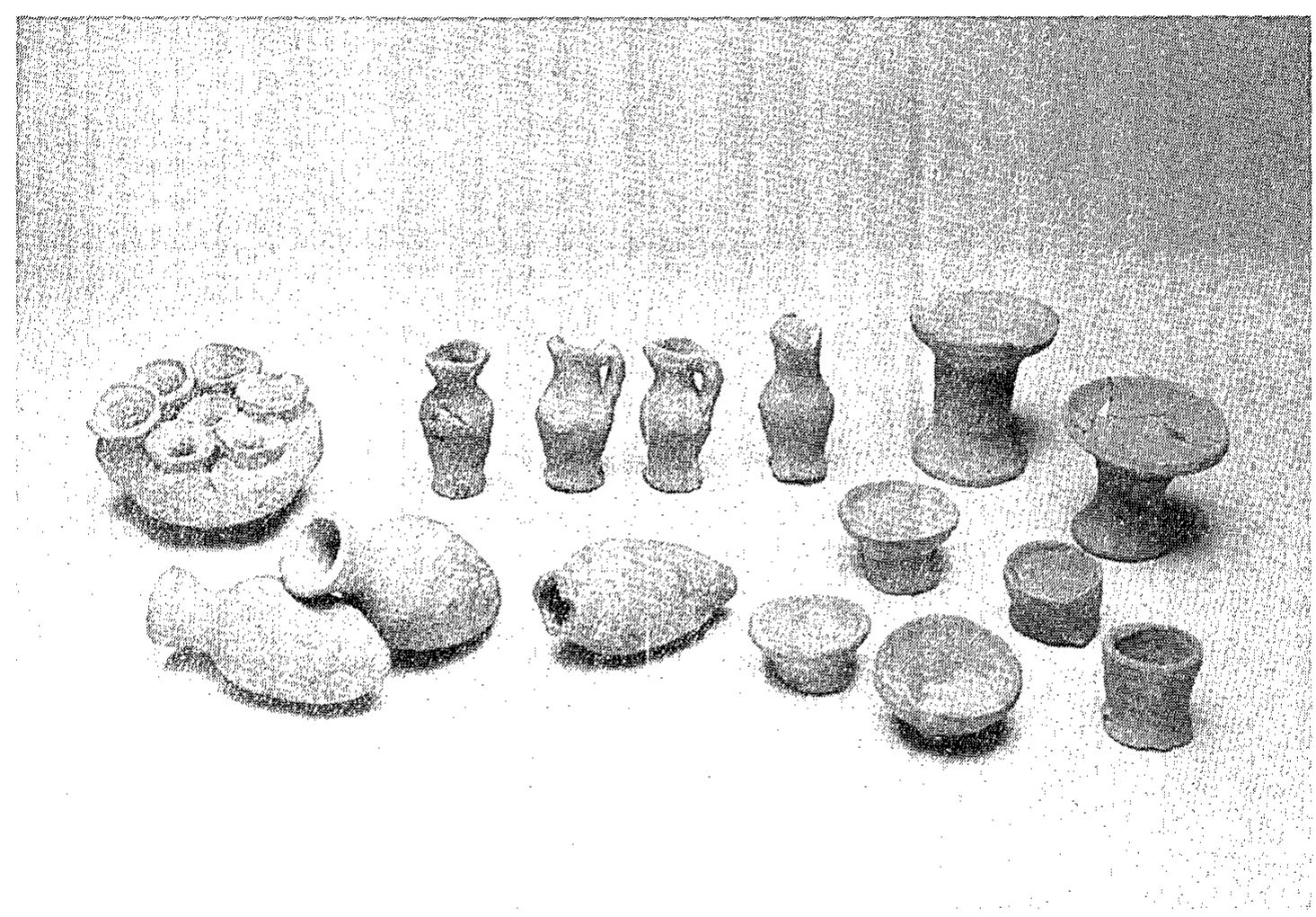 Fig. 24. Votive miniature vessels from the Middle Bronze Age cultic place.  constructional fill of the Level IV Palace B. Room 7059, surrounded at least on three sides by stone walls, was found in Sq. T/ 11. Square U/ 11 contained segments of two brick walls (W 7112 and W 7121), which probably belong to the same structure as the two massive brick walls uncovered by the British, or possibly forma continuation of the latter (Fig. 19).2 A complete human skull was found lying ona Level VI floor (Fig. 25), in parallel to the human remains uncovered on the floor of the Level VI ‘pillared building’ in Area S (see PR IT-:116; Pl]. 25:2). This is possibly another indication of the catastrophe that brought Level VI to its end. 