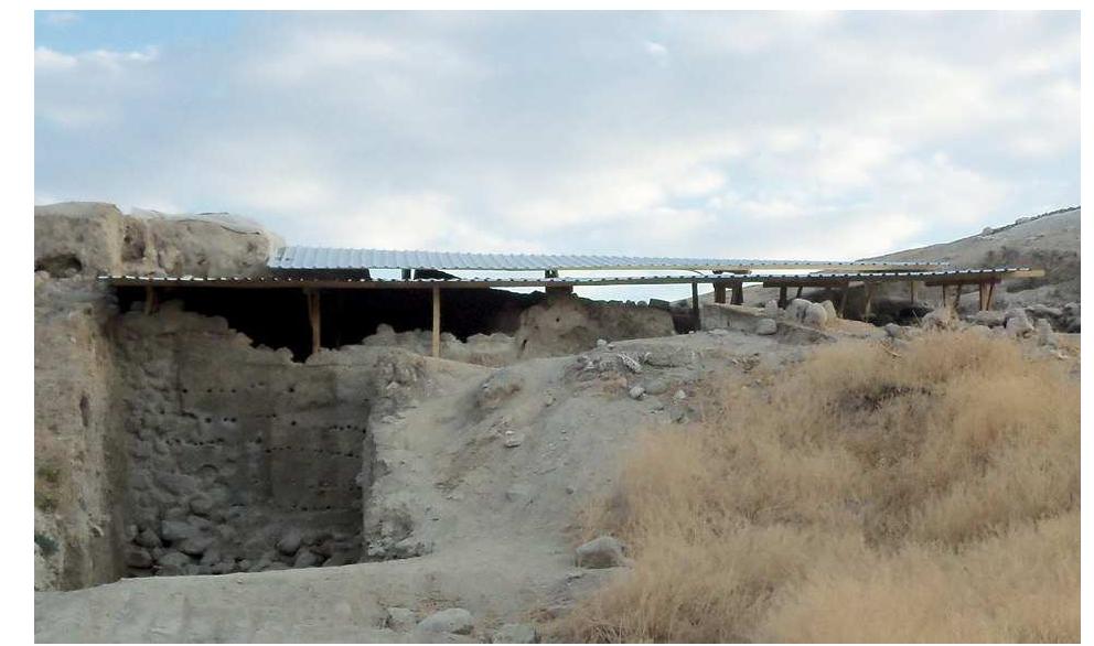 bases, obtained by filling old tires with concrete;  Figure 2: General view of the shelter over Operation A. 