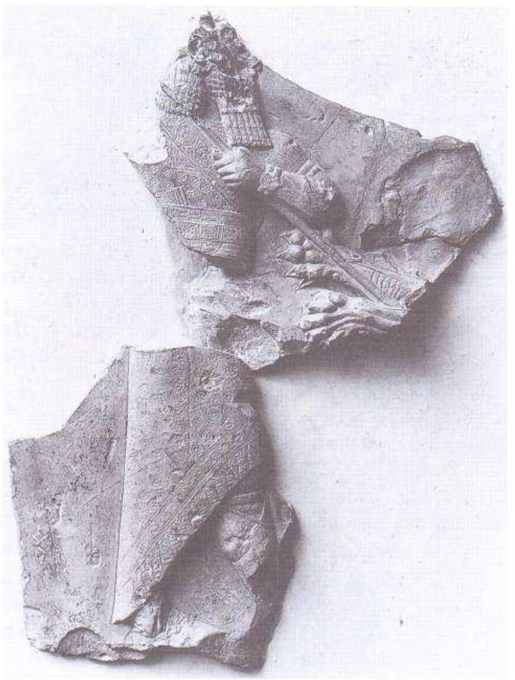 Figure 11, Plaque of king killing a lion, From Nineveh.  The largest and best-known of the “sculptors’ mod- els”, Figure 11, is a plaque of fine fossil clay from the  Anomer fragment, Figure 13, was made about the seventh or sixth century BC. The material is a dark red- dish-brown clay, evi- dently chosen or mixed for its good quality, which has been slight- ly heated to grey in parts. The fragment is recorded as coming from Borsippa, but no great reliance can be placed on the precise provenances some- times assigned in in- ventories for objects,  broken underside reveals it to be made of unfired clay. The material appears similar to the Assyrian fossil clay, possibly brought to Ur from some distance. The statue was found in a domestic chapel attached to a living-room, and is elaborately painted, which demon-  strates that it was a finished object, not merely a model for something else.  arsenal at Nineveh. It represents a seventh-century Assyrian king killing a lion, in a style resembling that of alabaster wall-panels in Room S of Ashurbanipal’s Palace, but those are in much lower relief. Some of the clay seems cut and sculpted, but the lion’s head was attached separately and has flaked away. Figure 12 shows gouge marks across the king’s face and beard close to the broken edge of the plaque. This deface- ment suggests that it had been displayed in an acces- sible place, such as a palace shrine, and that it, like the stone wall-panels, attracted hostile attention when Ni- neveh was sacked. So it can hardly have been a “model”. Probably other large Assyrian plaques had similar functions, as independent objects rather than as sculptors’ models. Hrouda suggested this for two fine seventh-century pieces from Ashur (Andrae 1977: 230- 3, 313: VA 6725 and another of uncertain provenance); 