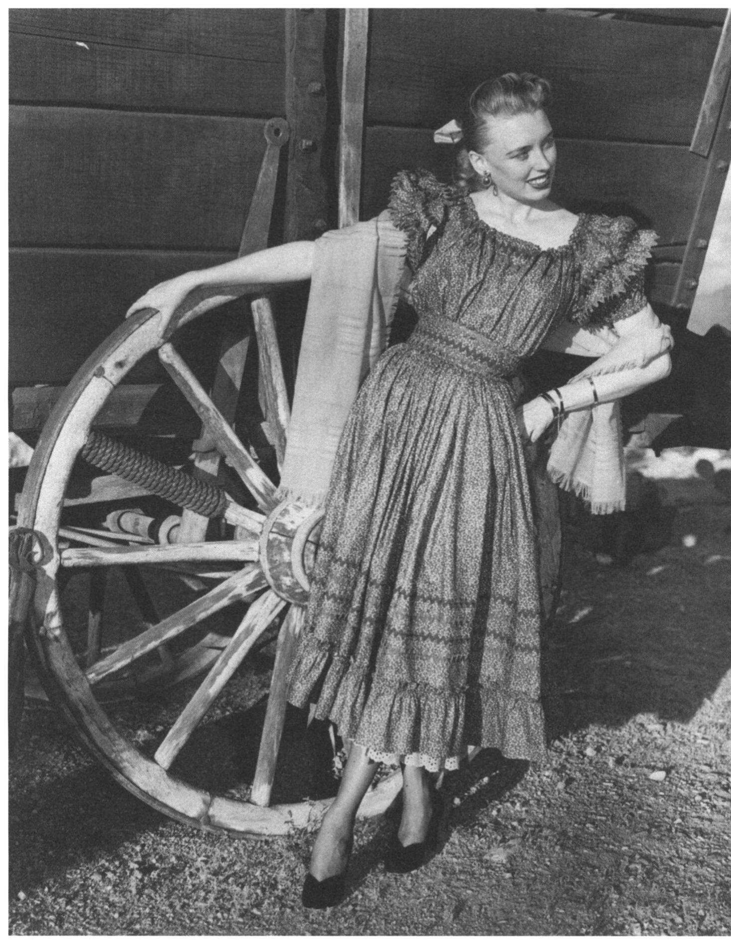 This calico pioneerstyle dress with rickrack braid, by