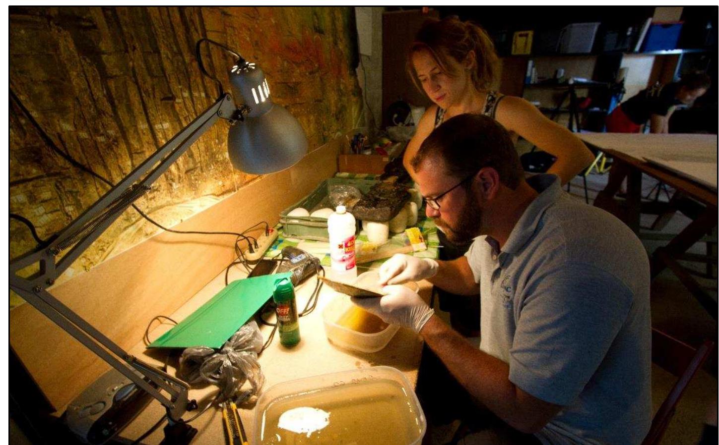 Figure 2-22. An artifact from the Gnalié shipwreck site being chemically treated by Chris Dostal anc Katarina Batur, conservation specialists, in the temporary laboratory of the Gnalié Project. (Photo: Reprinted with permission from Govoréin, 2014) 