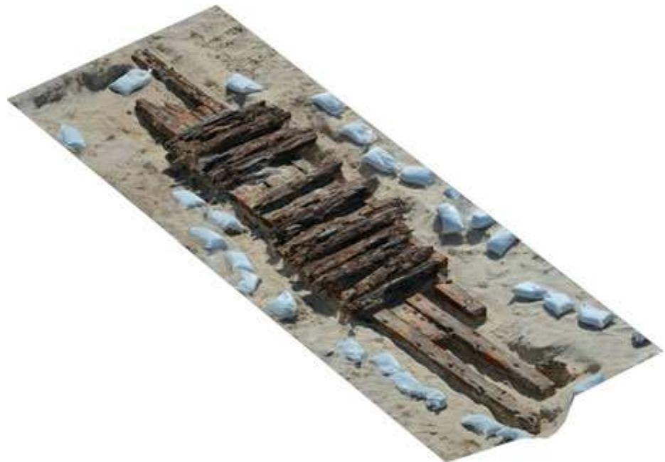 Fig. 2. Aspect of the Lagoa do Peixe photogrammetric model (R. Torres)  SOULLCIH DidZ@li (Pls. 2).  The site was composed of four disarticulated wooden structures found partially buried in the sand and spread over an area of approximately 1200 m° in the swash zone of the beach profile near the watermark (the part of the beach extending from a nearshore shallow depth to the limit of maximum inundation). Excavations revealed the remains of a wooden ship in the range of 300 to 400 t, with a length overall between 40 and 45 m, a maximum beam between 7 and 10 m, and a depth of hold around 4 m (Fig. 3). Moreover, careful examination of cargo evidence, timber scantlings, and construction techniques indicates a large two-masted or a small three-masted sailing ship of the mid-19th century, possibly a merchant schooner from Prussia, which sank in the area with a cargo of coal from Cardiff (Torres 2015). 