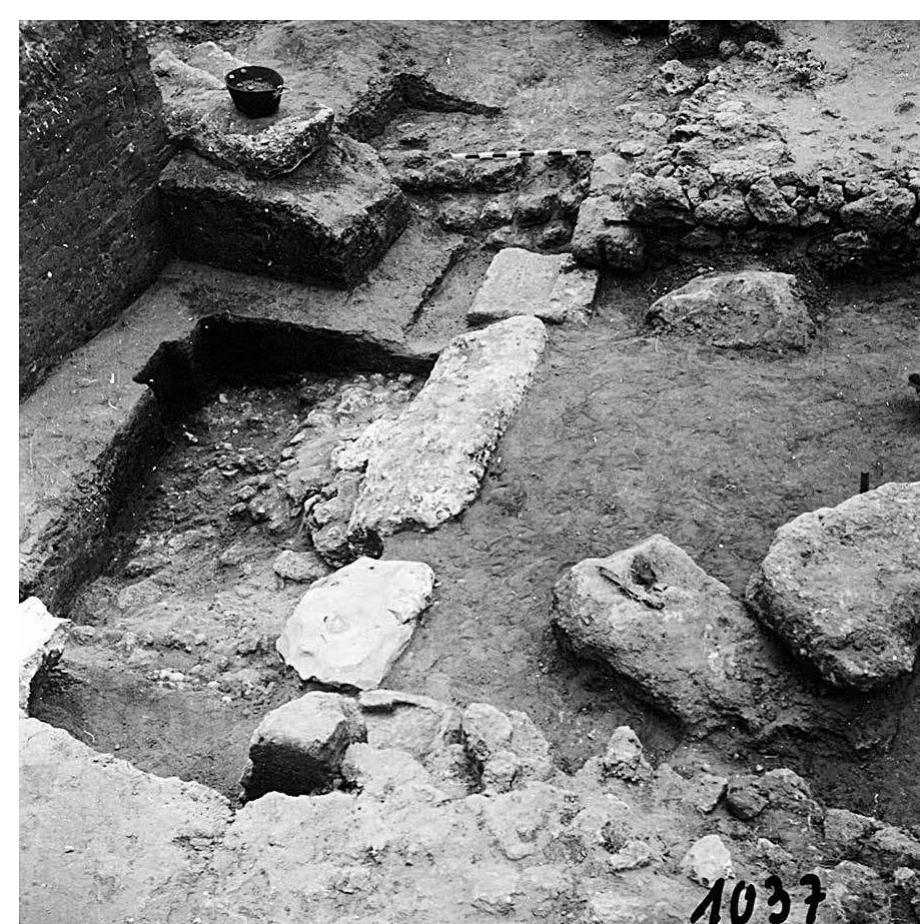 FIG. 9. Eastern threshold of level IVB (phase RG-4a) gate and sloped roadway (at left), as exposed during 1962 excavations by Kaplan, view to the south. Note that the large stones seen to the right within the passageway belong to the level IVA thresh- old, which fell into the excavation area following its exposure in 1956 (field photograph 1037, Kaplan Archive; courtesy Israel Antiquities Authority). 