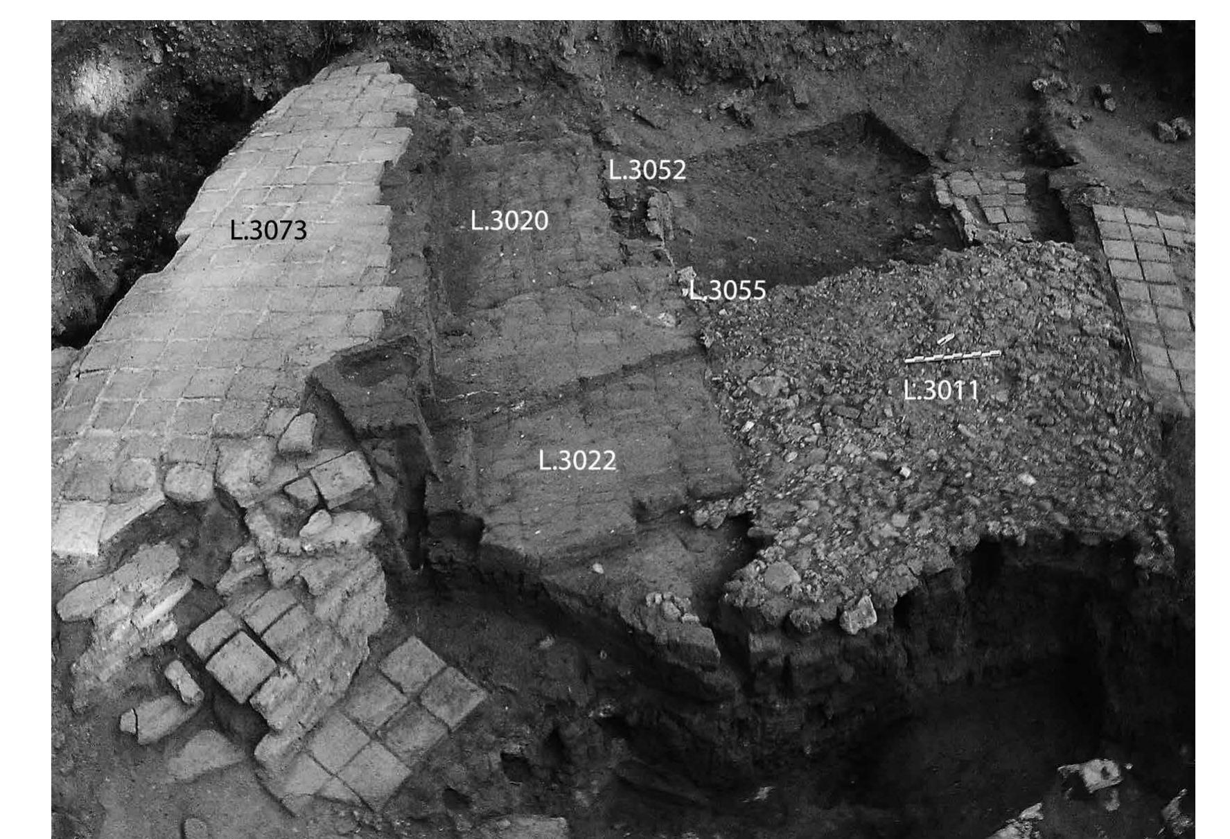 FIG. 26. RG-3b gate and stone subfloor of passageway (L.3011), including RG-3a restoration (L.3052), view to the southwest. Both phases were conflated as level IVA by Kaplan (JCHP photograph 2012-P0035). 