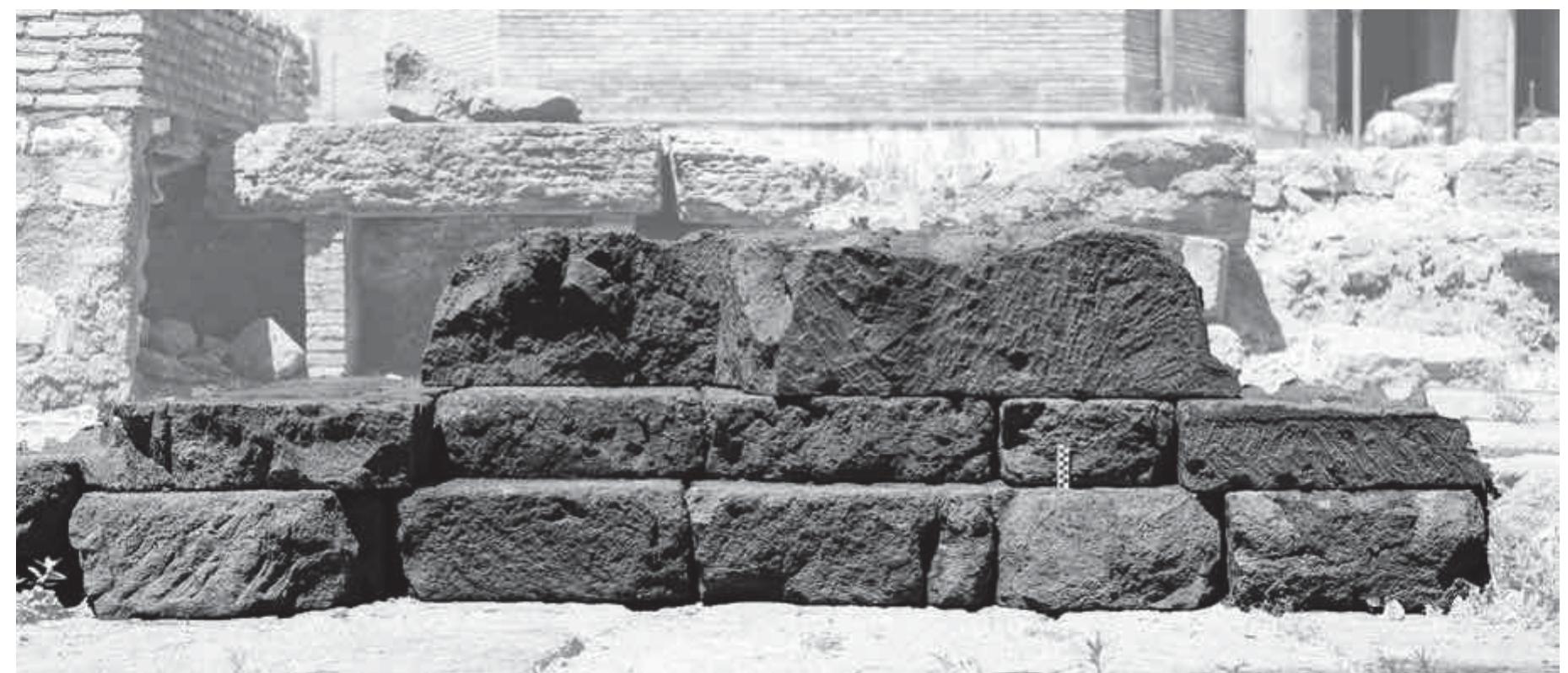 Fig. 5. Section of eastern altar, looking north, 10 cm scale (Author).  The usual formal comparanda for the U-shaped altars at S. Omobono are the eponymous monuments of the Sanctuary of the Thirteen Altars (or ‘Madonnella’) at Lavinium, in particular Altar XII, dated to the mid-4" century BCE (fig. 7), and the similar Altar XI°°, An even closer comparandum in plan, design and profile is the U-shaped altar at Ardea, loc. Fosso dell’Incastro (fig. 7, F. dell’Incastro 1’), which measures ca. 4.20 x 2.28 m, exclusive of platea — dimensions very close to those of the western altar at S. Omobono”’.  — _ ‘+ _ 7 * diesem 7 7 oom 