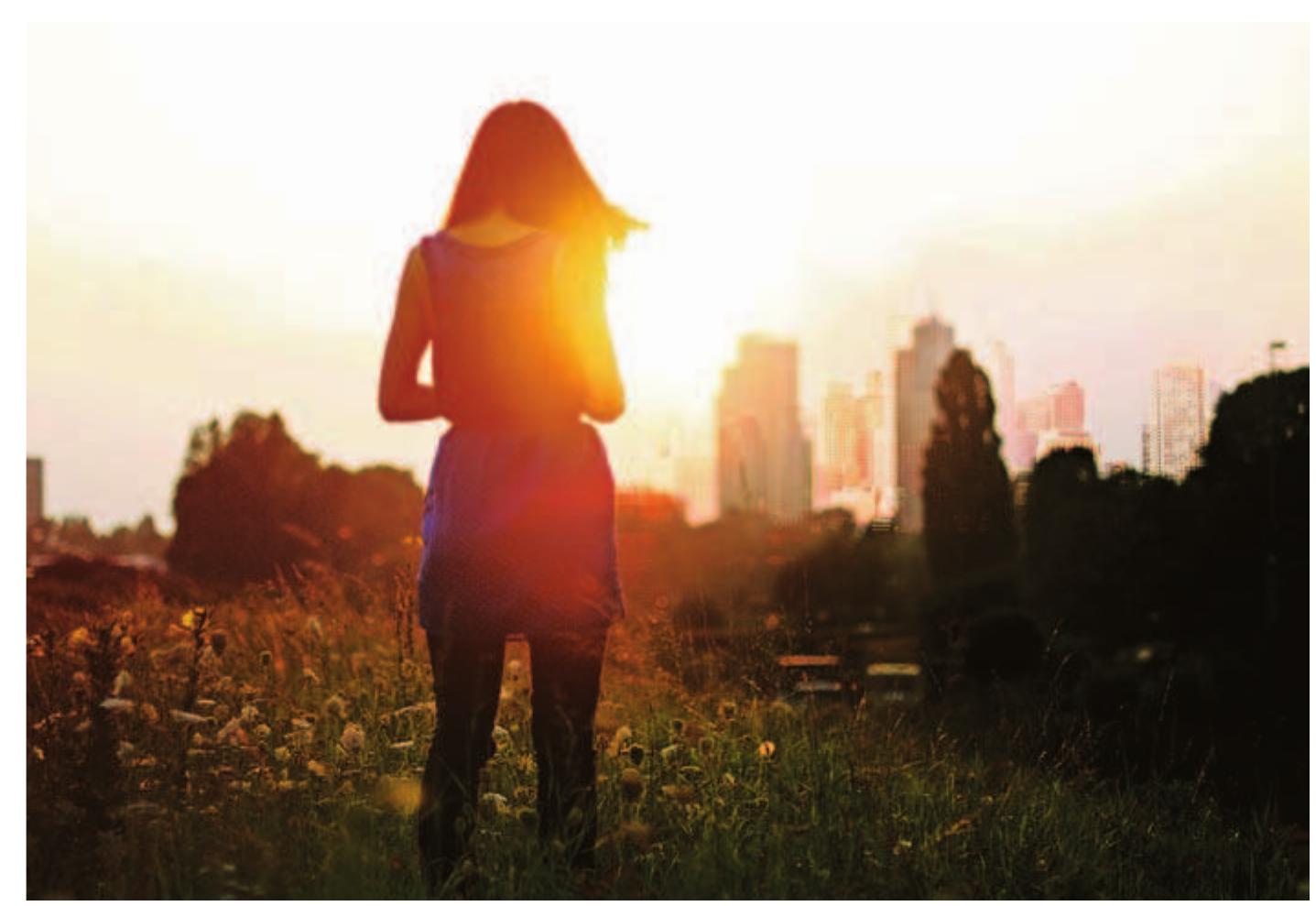 GDP does not accurately measure sustainable improvements to human well-being and quality of life, the authors contend. A young woman in Boston enjoys the sunrise. 