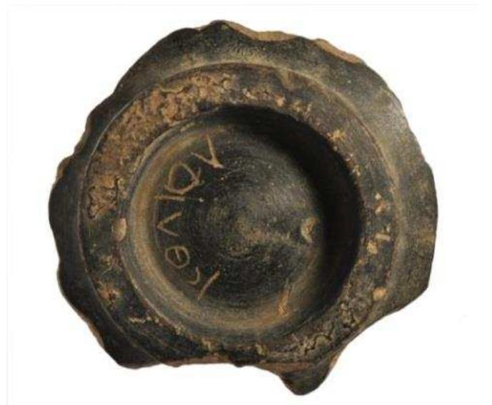 Figure 16. Fragment of locally made Hellenistic black ware bowl from Naukratis with the name ‘Kolios’ incised underneath the foot. British Museum, 1910,0222.225.a.  Figure 15. East Greek banded oinochoe from Naukratis, 6th century BC. British Museum, 1886,1005.20. 