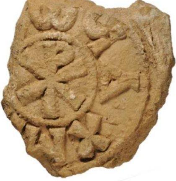 Figure 21. Plaster amphora stopper from Naukratis with impressed decoration including the Christian symbol chi-rho in the centre, 4th-7th century AD. British Museum, 1888,0712.43. 