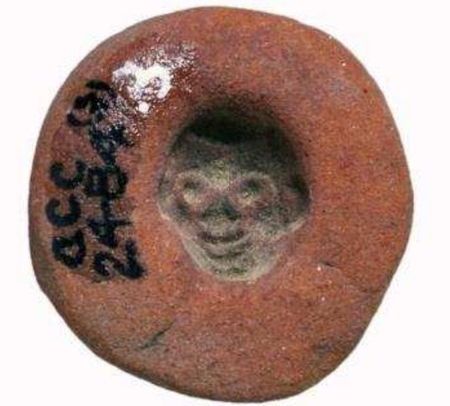 The ‘faience factory’ excavated by Petrie just outside the Aphrodite sanctuary is the main findspot for the well over 100 scarabs in faience and Egyptian blue paste Known today fro  Figure 57. Scarab in blue paste, a typical product of the ‘scarab factory’ at Naukratis, early 6th century BC. Museum of Fine Arts, Boston, 88.866. Photograph © Museum of Fine Arts, Boston.  Figure 58. Terracotta mould for a scaraboid in the shape of a Black African head, early 6th century BC, from the ‘scarab factory’ at Naukratis. Redpath Museum, Montreal, 2484.03. Photograph © Redpath Museum, McGill University. 