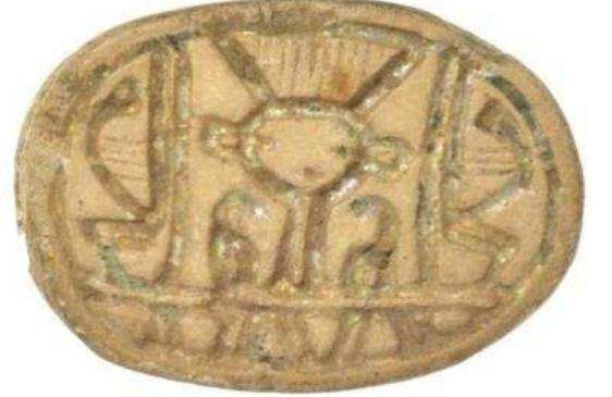 Figure 60. Glazed steatite scarab with a stylized heac of Hathor flanked by red crowns, from the ‘scarab factory’ at Naukratis, possibly Second Intermediate Period or Middle Kingdom (first half 2nd millennium BC). City Art Gallery & Museum, Bristol, H5115.8. Photograph © Bristol Museums, Galleries & Archives  Figure 59 Stone amulet in the shape of a wedjat eye, Late Period (664-332BC), from Naukratis. Petrie Museum, London, UC52358. Photograph © Petrie Museum of Egyptian Archaeology, UCL.  In addition to faience, many Egyptian amulets (Fig. 59) and scarabs in stone have also been found at Naukratis. 