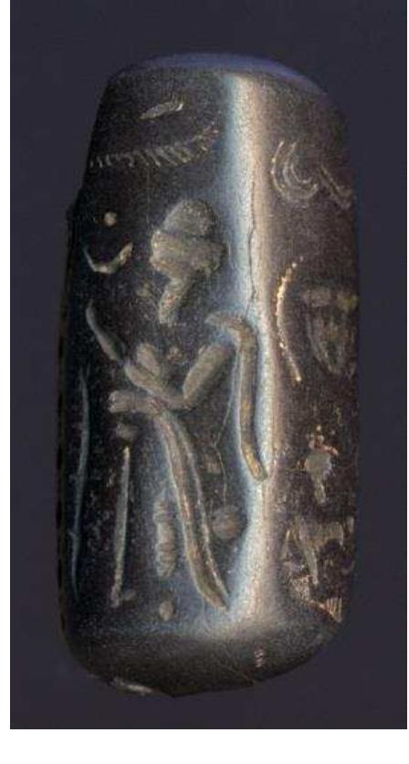 Figure 61. Syrian hematite cylinder seal from a house in the town of Naukratis, probably made in Aleppo, late 18th—early 17th century BC. British Museum, 1886,0401.1722.  Figure 62. Clay seal impression with hieroglyphic inscription naming the ‘prophet’ Hor, a high official in the Egyptian hierarchy of priests. From Naukratis, late 7th—late 5th century BC. British Museum EA27575.  2.12. Jewellery and mirrors 