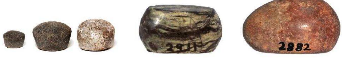 Figure 66. Weights from Naukratis, from left to right: Three Egyptian stone weights: 2 qedets and (twice) 1 deben; (Bolton Museum, 1925.20.1—3; photograph © Bolton Library and Museum Service); small discoid stone weight: half a shekel (Oriental Institute, University of Chicago, E2911; photograph © Oriental Institute Museum, University of Chicago); teardrop stone weight (Oriental Institute, University of Chicago, E2882; photograph © Oriental Institute Museum, University of Chicago). 