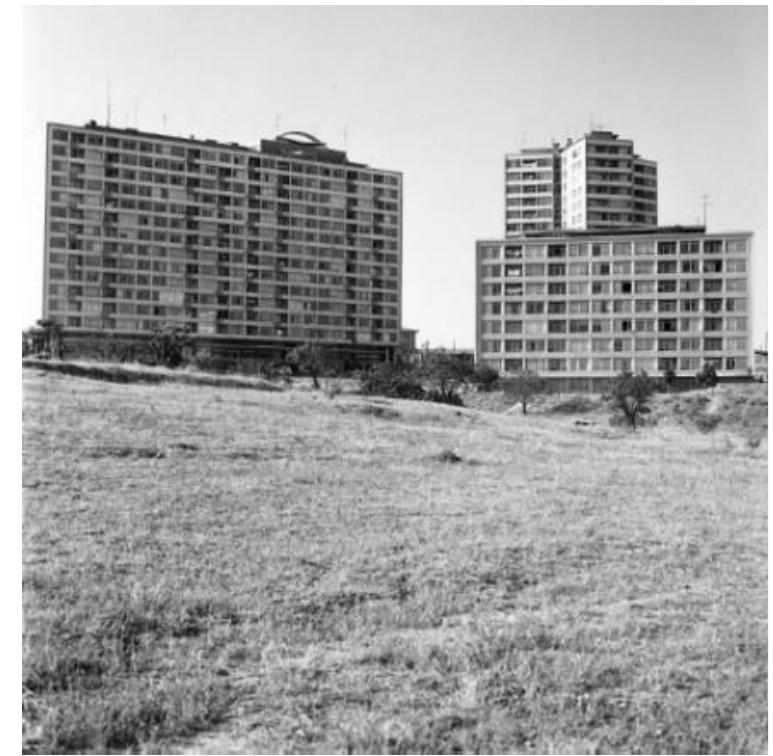 construction of other settlements especially after the 1970s’ migration (Bilas Sites, Umit Coop Housing Blocks, Idil Sites) and gated community (Middleist residence) (Table 1). The neighborhood has been undergoing a spatial, social and demographic transformation in recent years. Currently, there are site-style housing types with different typologies located linearly on three separate dead-end streets (these are; Idil St., IETT Blocks St., Halit Ziya Tiirkkan St. in the neighborhood.  Figure 1. a. Hilton and Yildiz Blocks of ETT; b. The Big Block (Hilton Block) (Source: Giiltekir Cizgen) 