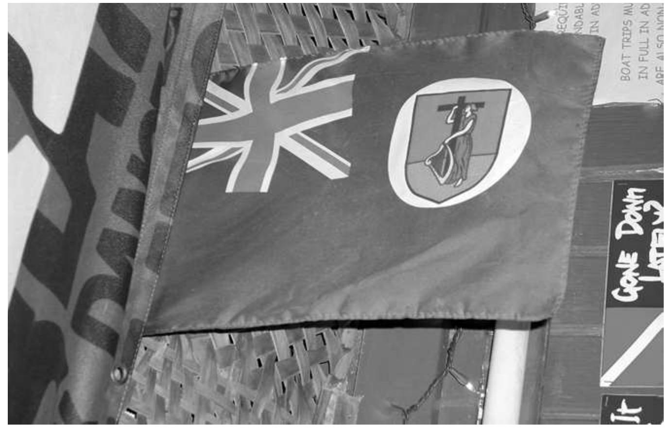 Figure 7.4. Montserrat flag hanging in a roadside bar. © L. McAtackney, 2011.  absence hints at a salient difference between more modern nineteenth- and 