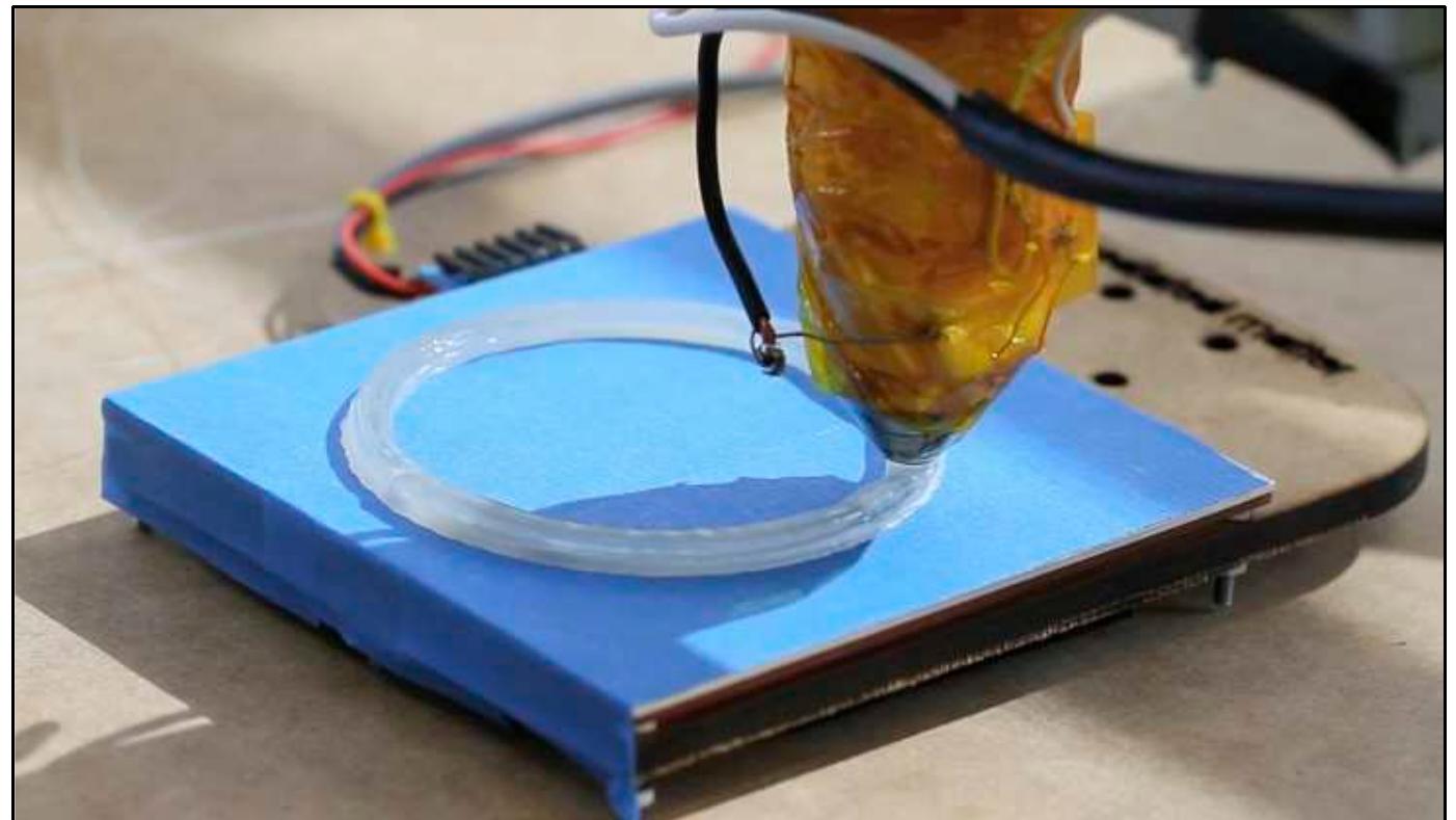 A print test shows the molten hpde being extruded onto the