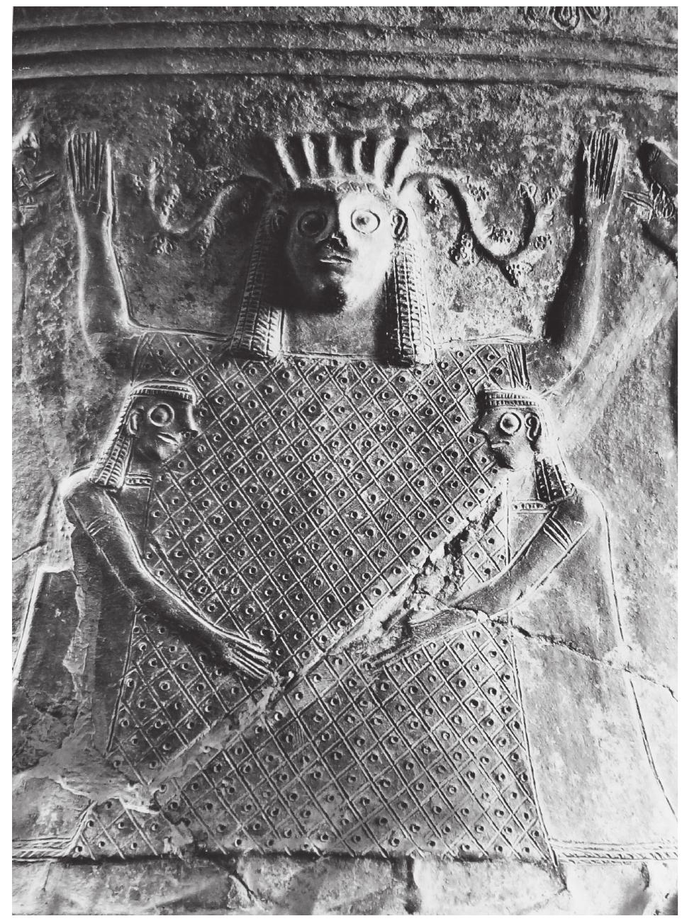 Figure 5.1 The central group decorating the neck panel of the Boeotian amphora National Archaeological Museum, Athens  5898. (© National Archaeological Museum, Athens: Hellenic Ministry of Culture and Snorte: Archaeological Receints  Abstract: The neck panel of a relief amphora from Boeotia in the National Archaeological Museum and a fragment fror Xobourgo in the Museum of Tenos are decorated with an impressive frontal figure with upraised arms escorted by two smal attendants pressed closely against her. Two lions in profile rear on either side of this central group. In this chapter, the differen approaches to the iconographic subject are considered and a new reading of the image proposed, interpreting it as an optica transcript of Iliad 21.479-84 according to which Artemis could behave as a lion towards women and was, by Zeus’ permission free to kill whomever she wished. It is suggested that the frontal figures on the neck panels represent Artemis as Potnia, while the small female worshippers attempt to placate the all-powerful deity, asking her to avert the danger embodied in the lions and to protect them in marriage, pregnancy and labour. The paper locates other iconographic subjects of the same period anc on the same pottery type that apparently represent visual translations of Homeric verses. 