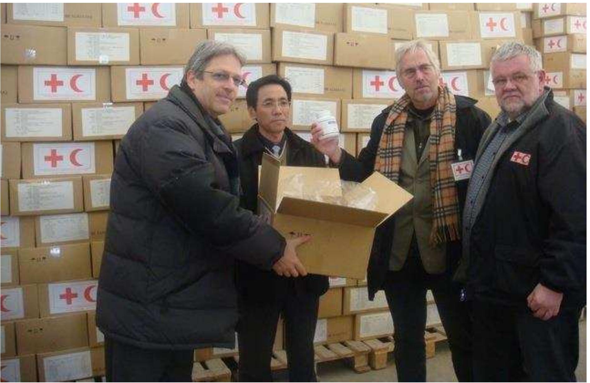 Felix Abt and O Son Gun, his North Korean deputy CEO, handing the first large order of pharmaceutical kits, containing antibiotics and painkillers for adults and kids, won in a competition against pharmaceutical manufacturers in Asia and Europe, to representatives of the IFRC (Intl. Federation of Red Cross and Red Crescent Societies). (Image credit: Felix Abt) 