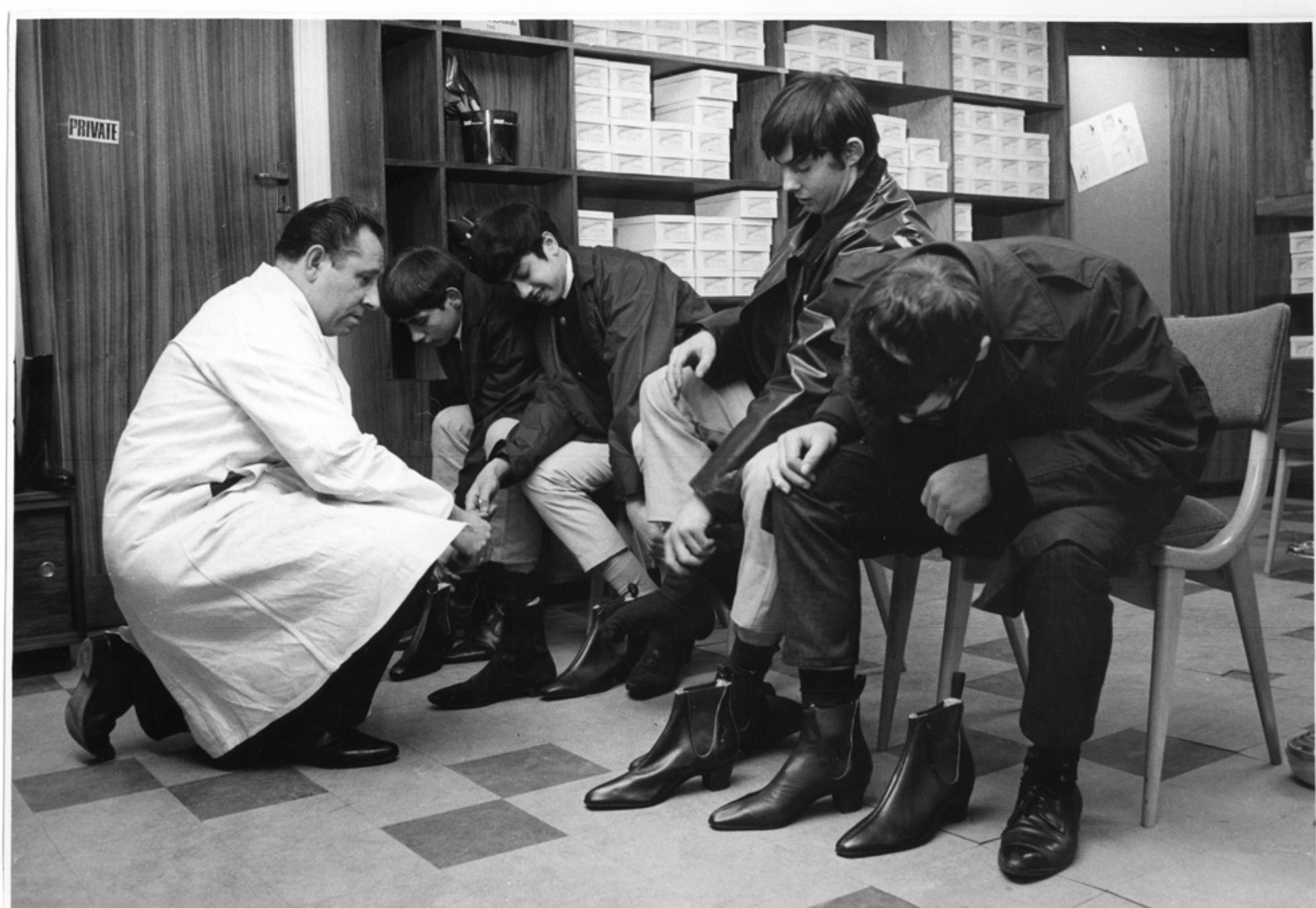 fetishistic at times, with users posting a series of photographs displaying all facets of a garment or documenting the moment a new garment was removed from its packaging. Users’ descriptions of purchases reflected the sheer joy that they found in shopping, with statements such as ‘just beautiful shoes,’ ‘these beauties,’ ‘clean and classy,’ ‘love it!’ and ‘couldn't be more pleased.’ It would seem that with online shopping individualising and privatising the experience of consumption, Modforum users were driven to describe and display their shopping on the forum to recapture the spectacle of shopping. In order for online consumption practices to enact subcultural lifestyle and maintain group solidarity in the same way as traditional consumption practices, they had to be discussed online for the benefit of other subculture members (Image 4). Subcultural fashion, once closely associated with public space, had moved from street to screen.  Image 4: 'Mods' try on Beatle boots at Annello and David, 1965, courtesy of Museum of London 