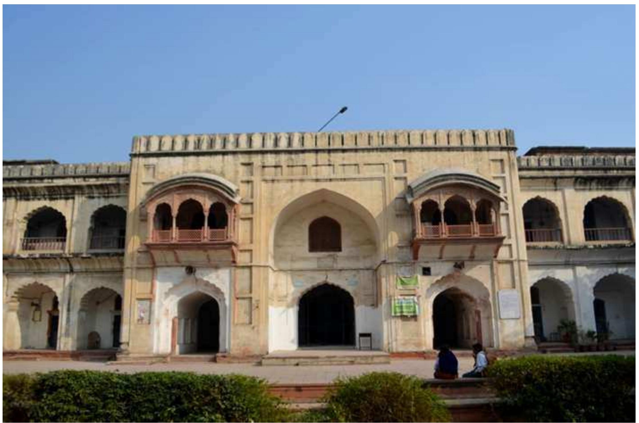 Fig.7. Entrance to the courtyard (Photograph by author)  The double storeyed Madarsa complex surrounds the large courtyard from three sides and includes the eastern, southern and northern wings.At the centre of each wing of madarsa is a protruding double height iwan (Fig.8) and layout of madarsa evokes the Persian iwan type arrangement. Each iwan is flanked by a double storey crenellated structure embellished by multi- lobed arches on both floors (Fig.9). All the madarsa wings once had verandah around the courtyard,  which have now been converted into class rooms at various places.  The double storeyed Madarsa complex surrounds the large courtyard from three sides and 