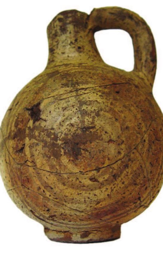 Fig. 9. Fragmentary Egyptian figure of bronze uraeus, Late Period, from Kameiros, Rhodes. British Museum  1864,1007.1195 (Bronze 147) (Photon: © The Triueteoee nf the Rritich Mijeoum)  Fig. 10. Pottery jar imitating Phoenician Bichrome Ware, 8" century BC, from Tell Nebesheh. British Museum EA22425 (Photo: © The Trustees of the British Museum). 