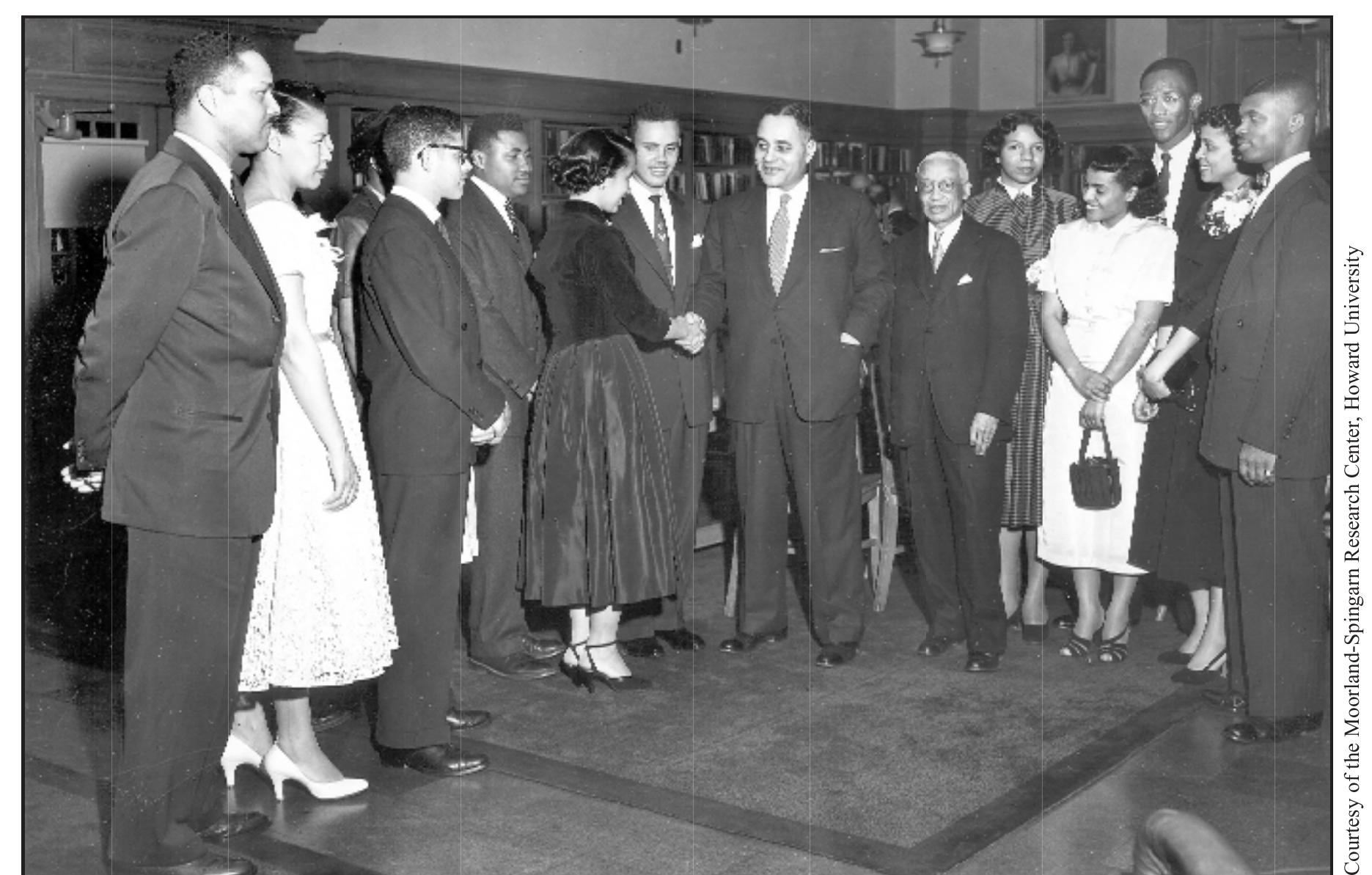 PHI BETA KAPPA INSTALLATION, HOWARD UNIVERSITY, 1953  Alain Locke (center right) and Ralph J. Bunche (center) participate in the nstallation ceremony of charter members of Phi Beta Kappa at Howard University 