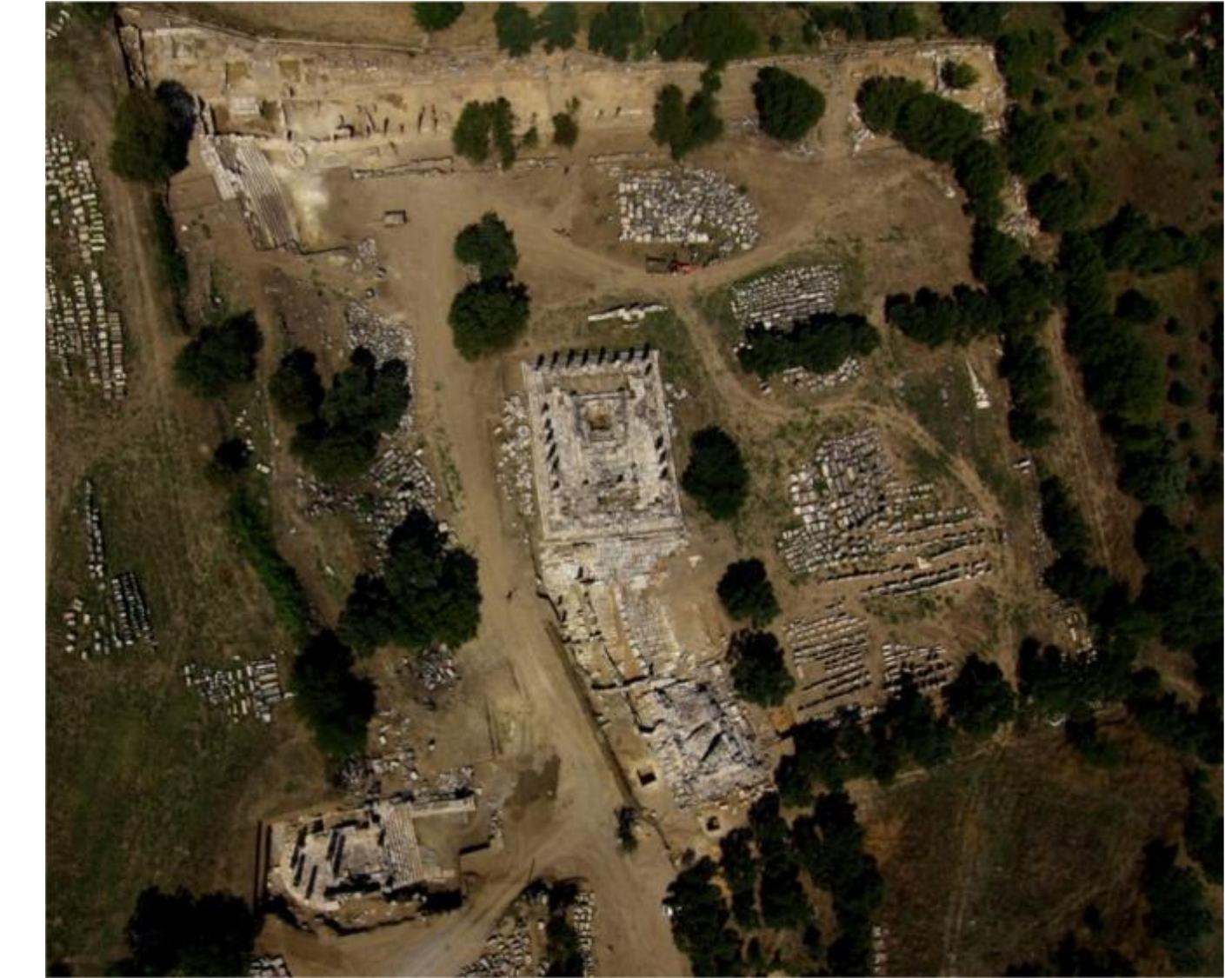 Figure 1: The Sanctuary of Hekate at Lagina  Ce  The Lagina Hekate Sanctuary was finalized by the zoning activities carried out in the Early Imperial period (fig. 1-2). According to this regulation, the outer walls of the stoas surrounding the four sides of the sacred area also functioned as a peribolos. However, the wal on the northeast corner of the sanctuary, located 11,5 m east of the border in the Early Imperial period, is giving hints about an arrangement that dates back to an older period based on both block dimensions and masonry technique (fig. 2). The walls are flat-edged with a pulvinated surface and built as a double row of pitch-faced stones and rectangular blocks. In 2009 in the north of the sanctuary”? (fig. 2), in 2011, in the west and south (fig. 2) of the sanctuary, excavations were carried out to determine the temenos borders. From this work, it was determined that the wall in the northeast also continued in the west, north and south. This situation has revealed that the wall in the northeast is actually a peribolos that surrounds the four corners of the sacred area. The masonry technique seen in the mentioned walls has also been detected in the Stratonikeia Lower City Walls, repair phases in Kadikulesi Hills, the western and northern walls!+. These walls in the city were dated to the 4th century BC and it was understood that a large-scale development activity was carried out in the city during the Hekatomnid Dynasty!’. The peribolos, which resembles the walls of Stratonikeia, apparently built as a result of Mausolos’ urbanization policy, was built in the framework of the same zoning activities and that perhaps the existing cult area was turned into an introverted area. Although there is no building dated to the 4th century BC in the sacred area, these walls prove the existence of an area for Hekate cult at least since the Late Classical period.  XN  
