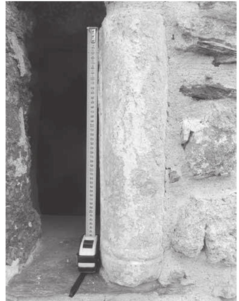 Fig. 5: Church of Sv. Nikola, Kosel (OH_ID_2075); spolium: marble ‘double half column’ (photo by C. Haubenthal).  Fig. 6: Church of Sv. Nikola, Kosel (OH_ID_2075); spolium: grey limestone or metacarbonate stone with casting hole (photo by C. Haubenthal).  OH_ID_2075; spolia - remains of a former church (?) (LA, EMA, MA, Ott)  The Church of Sv. Nikola in the village of Kosel (there are currently two churches, one old from  the end of the 14" and the beginning of the 15" c. AD, and directly next to it, in the northern  direction, one from the last few decades called Sv. Nikola). We recorded four relatively large  spolia connected with the old church. The most spectacular one is a piece of a ‘double half column’ in breccia-like marble (h. 51.5 cm, w. 28 cm, t. 13 cm), which is incorporated into the  southern window of the old church (it maintains its original function as it supports the frame of the window, see Fig. 5). These columns are representative for Late Antique and Early Medieval  churches, originally used as parts of balustrades or window supports. Three more spolia were  found in front of the main entrance to the old church (west of the church). These spolia are large  marble slabs and, according to the church personnel, they were found during building activi- ties connected with the reconstruction of the old church. The first is a rectangular (h. 35 cm, w. 70 cm, t. 36 cm) greyish metacarbonate stone or marble (?) with working traces on its surface, especially noticeable on its upper side. The second one is of a grey limestone or metacarbonate  stone, also rectangular, although broken on one side (h. 38 cm, w. 81 cm, t. 65+ cm). On the upper  surface, it has a casting hole (20.5 cm long) terminated by a circular hole (d. 15 cm, see Fig. 6). A quadrangular dowel hole 4x4 cm is located on the bottom of the circular hole. The rounded  