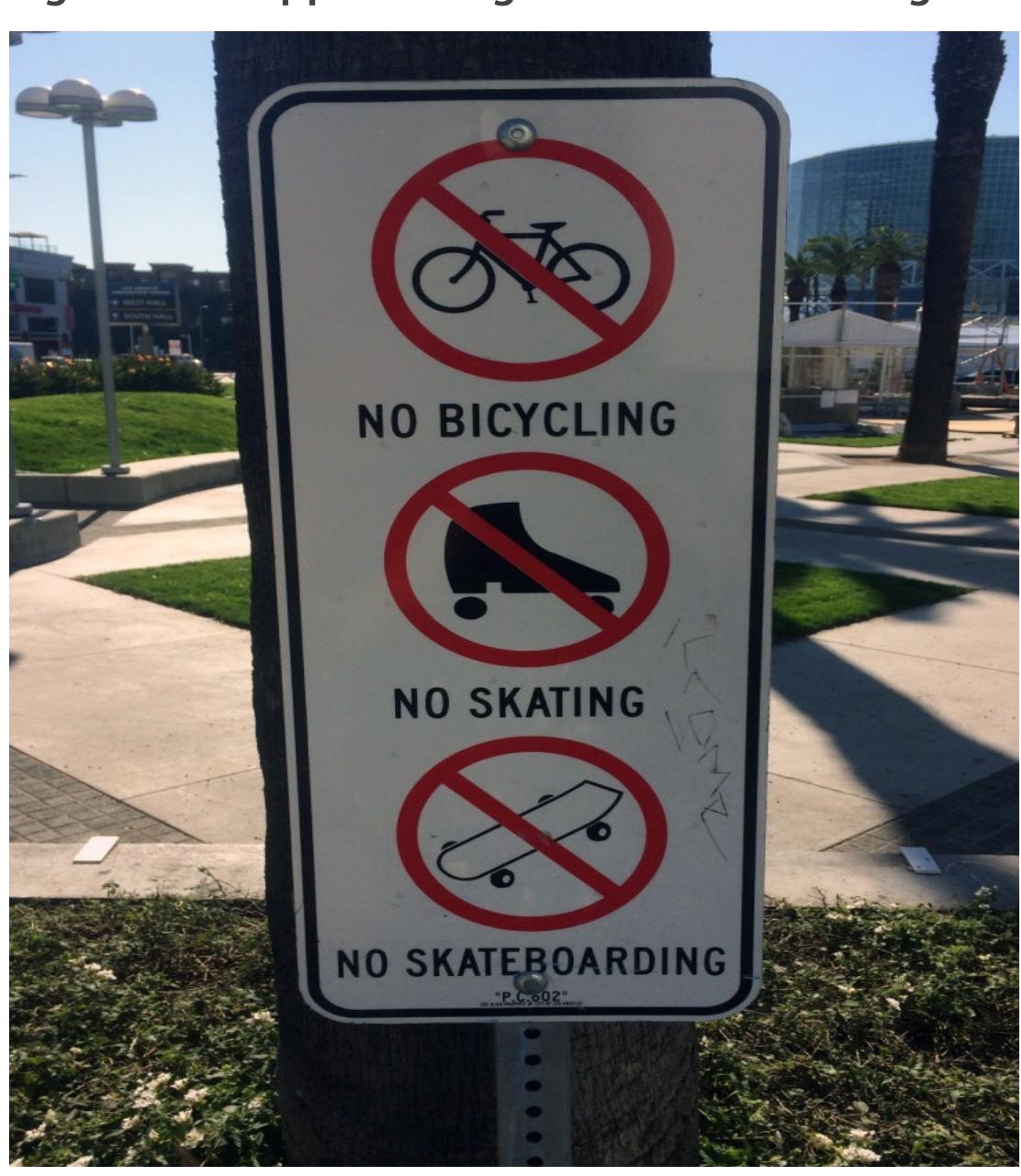 Exclusionary regulations reinforced with skate-stoppers on ledge behind. Photo by Chris Giamarino. 